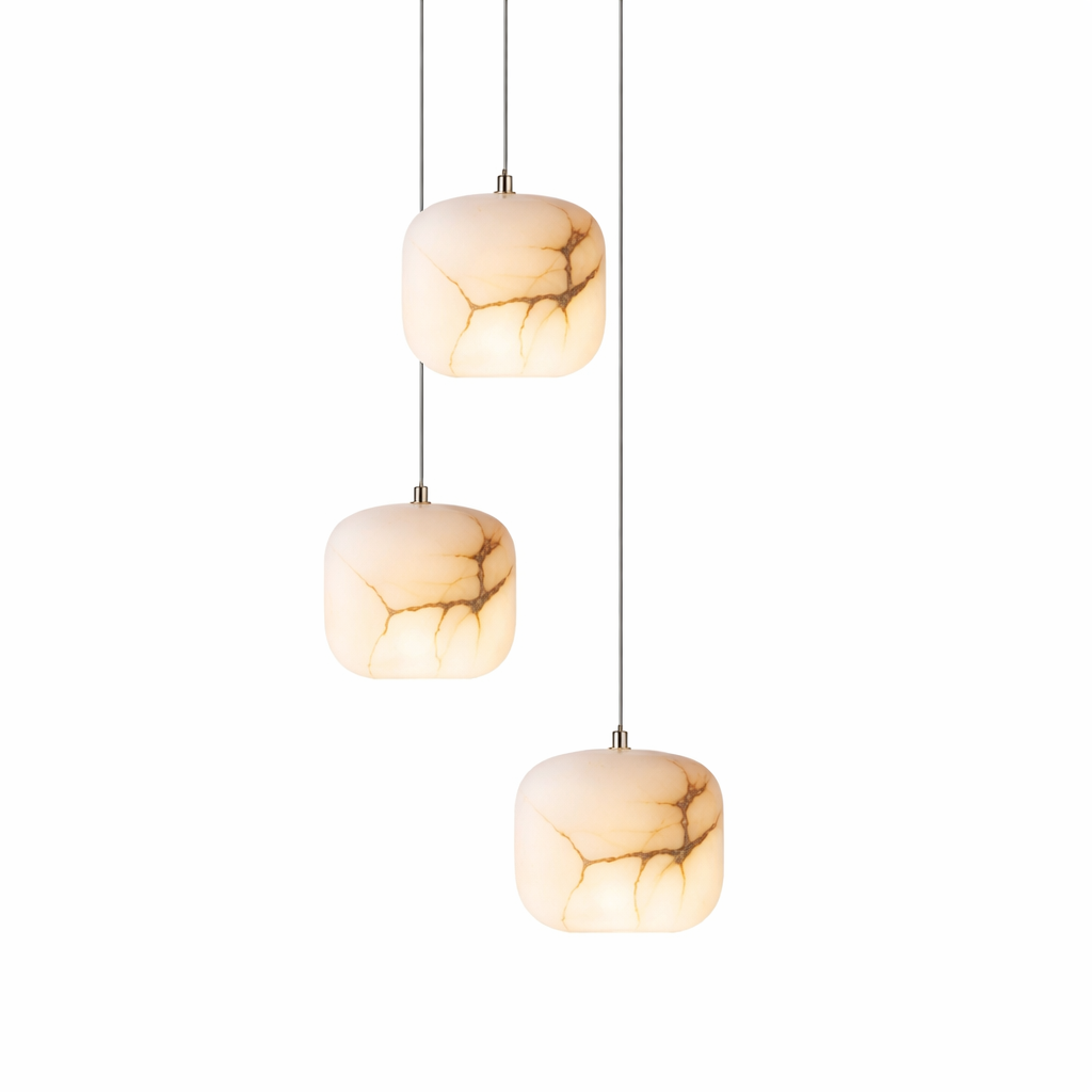 Detailed view of the VORELLI Leonardo Marble Pendant Light, showcasing the sculptural simplicity and the rich, natural veining of the stone as it emits a warm luxury glow.