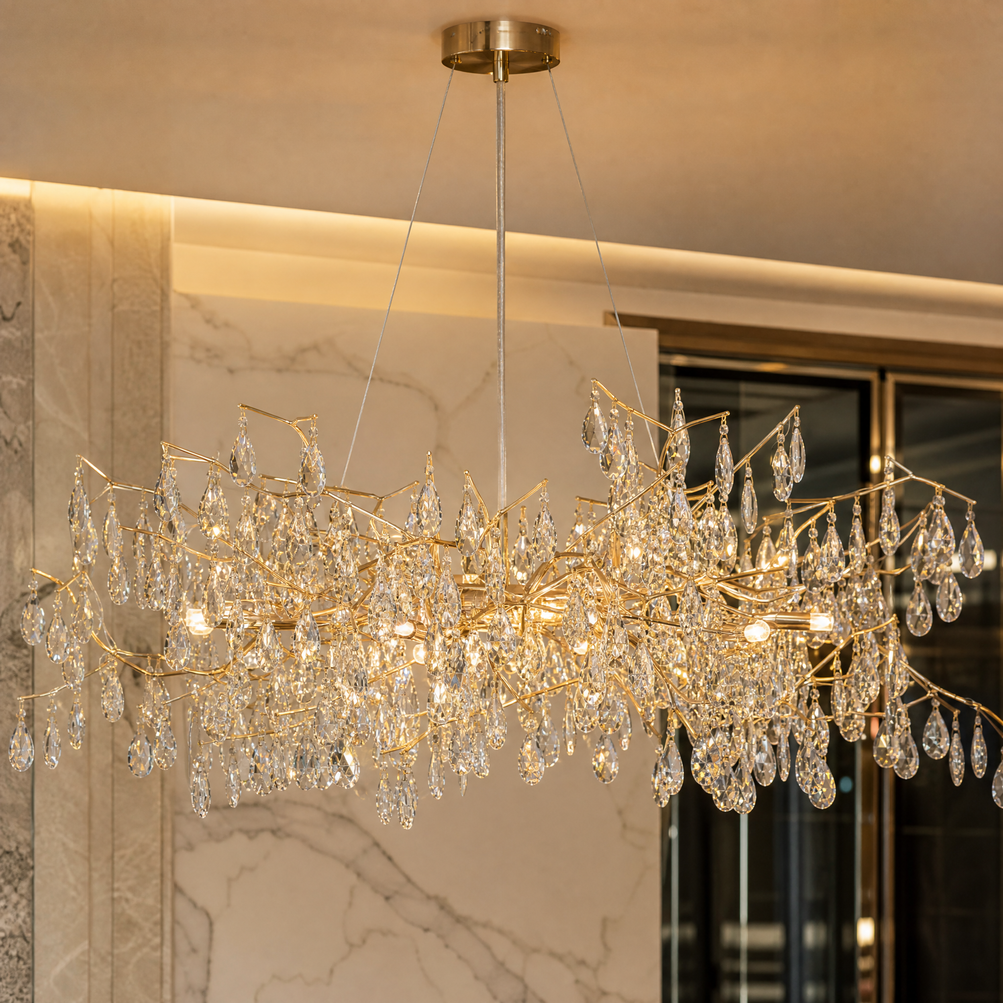 Macro closeup of the diamond-cut crystal drops on the sculptural frame of the VORELLI Dewdrop circular chandelier, showing the refined craftsmanship.