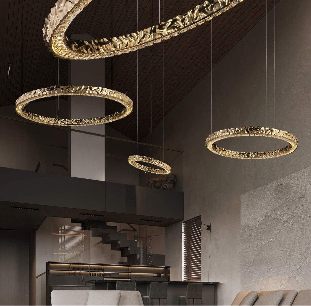 Close-up of the textured gold circular frame on the Ecliptica chandelier by VORELLI®