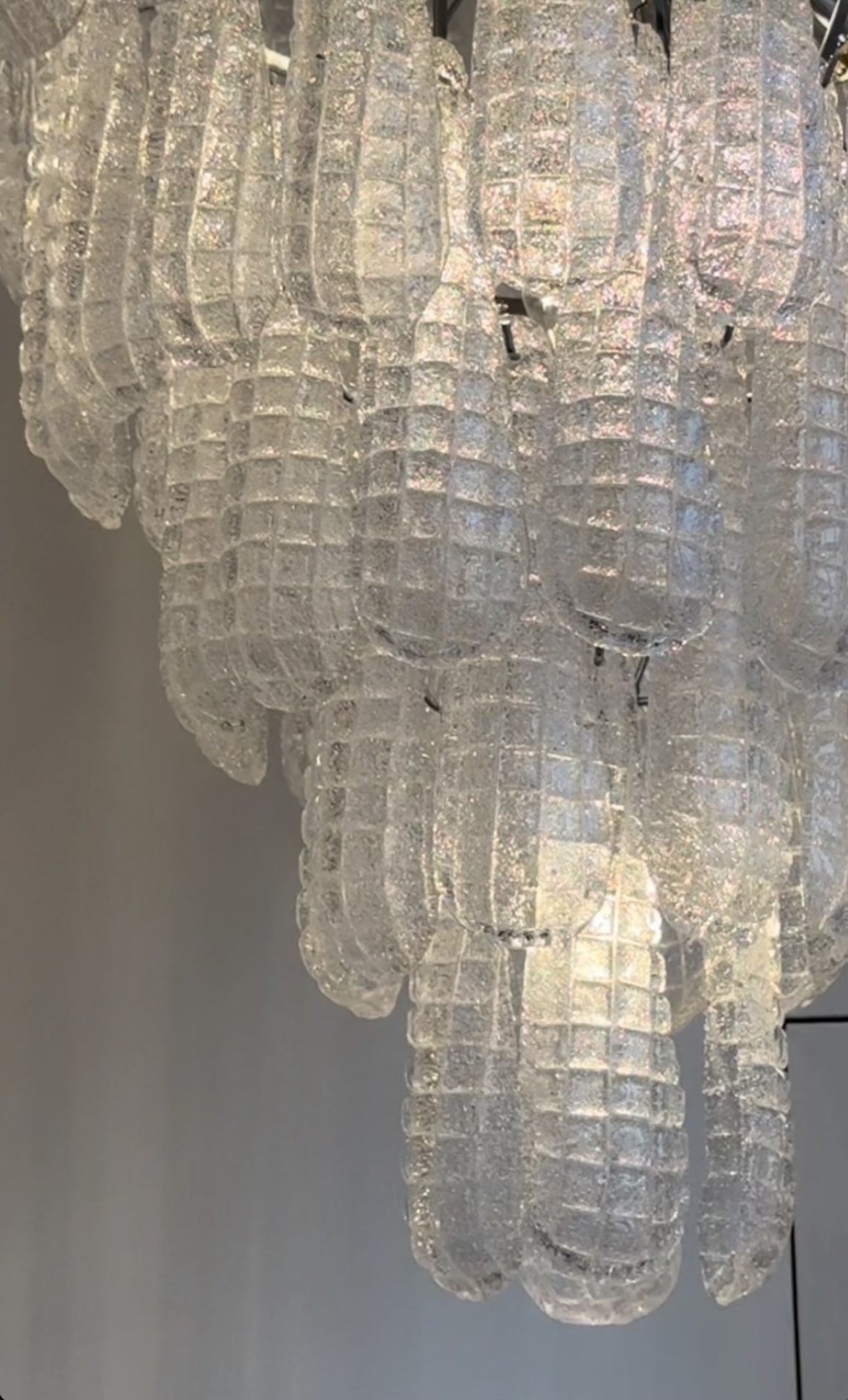 Close-up of textured glass elements on the Eclissi Circular Chandelier highlighting artisan craftsmanship