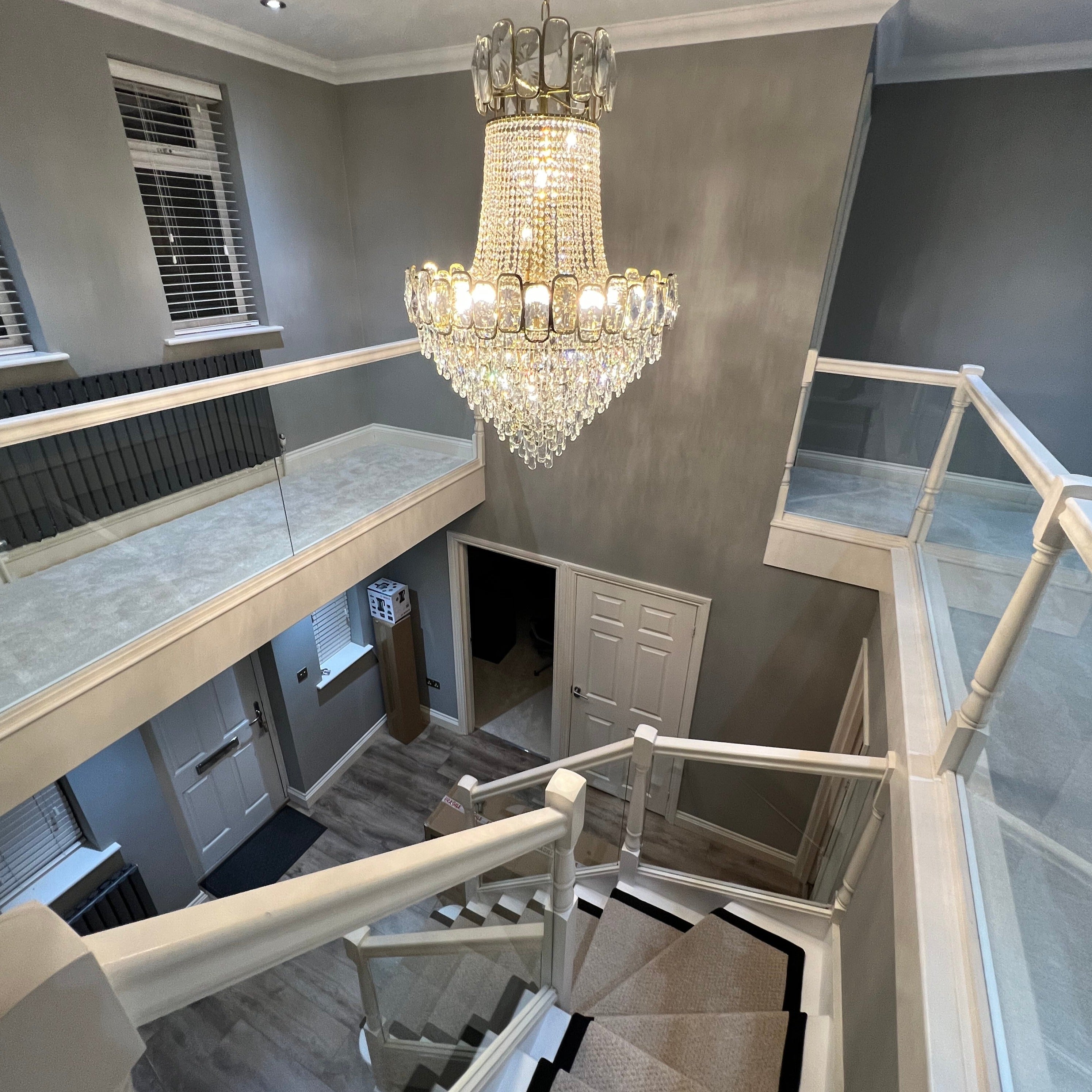 Overhead view of the Edison Grandeur staircase chandelier with layered crystal detailing by VORELLI®