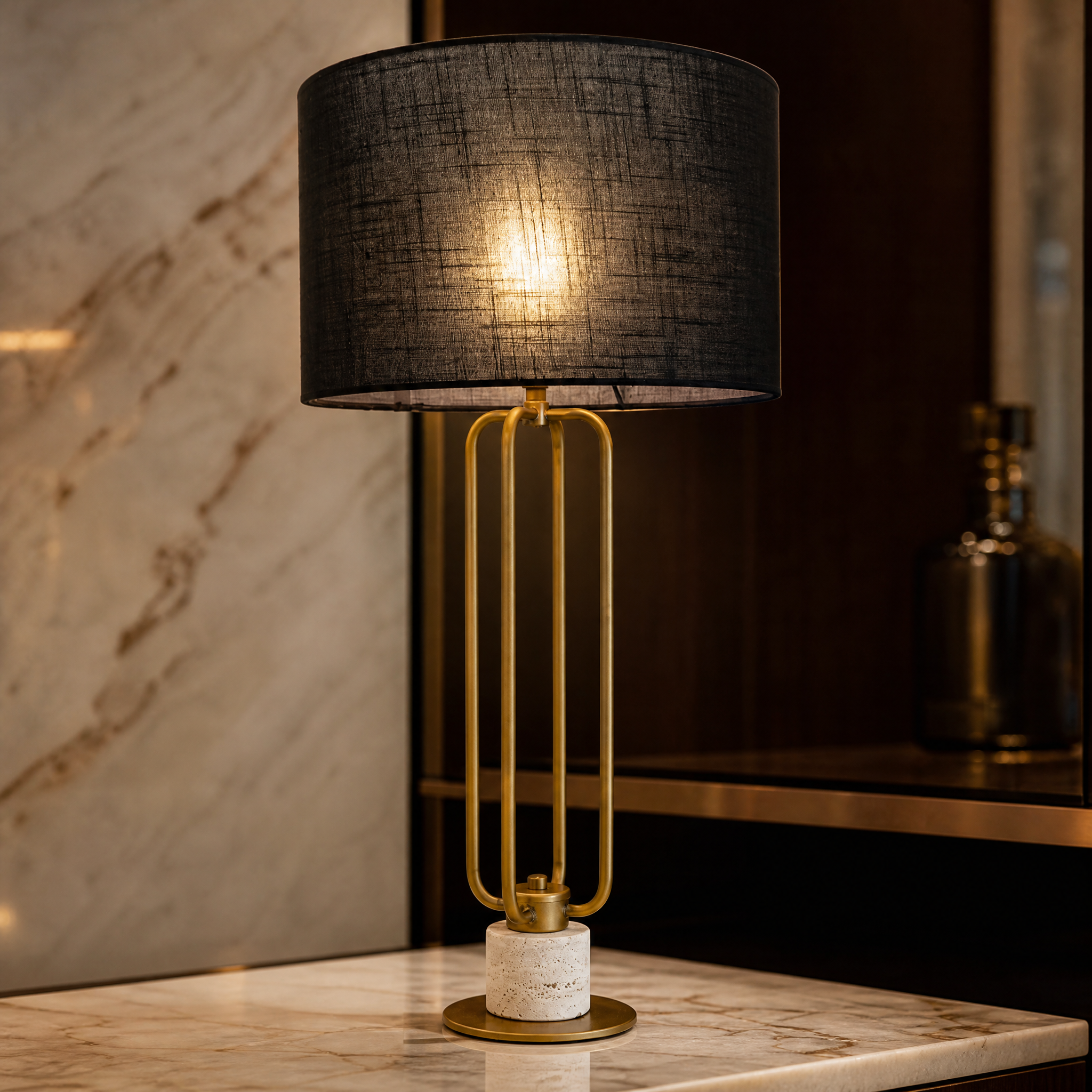 Close-up detail of the Elvara table lamp showing the tactile texture of the natural travertine stone base and the sleek antique brass frame.