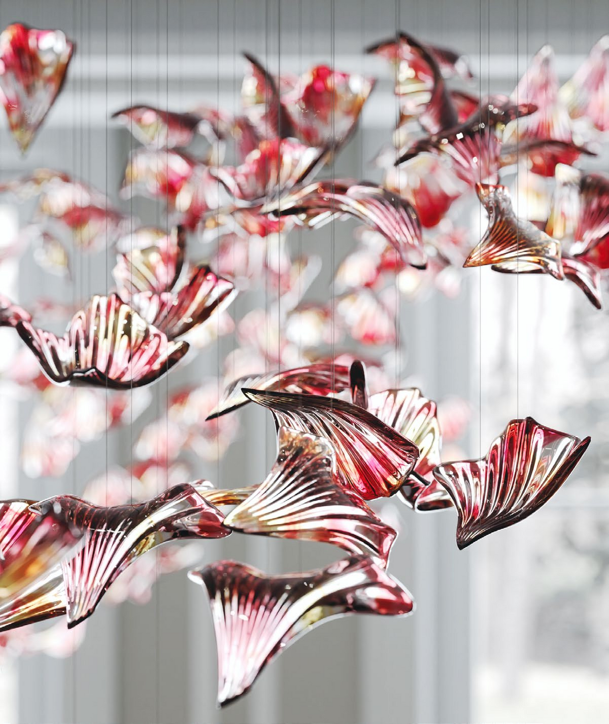 Detailed view of the amber tones and soft organic rhythm of the drifting glass elements within the VORELLI installation.