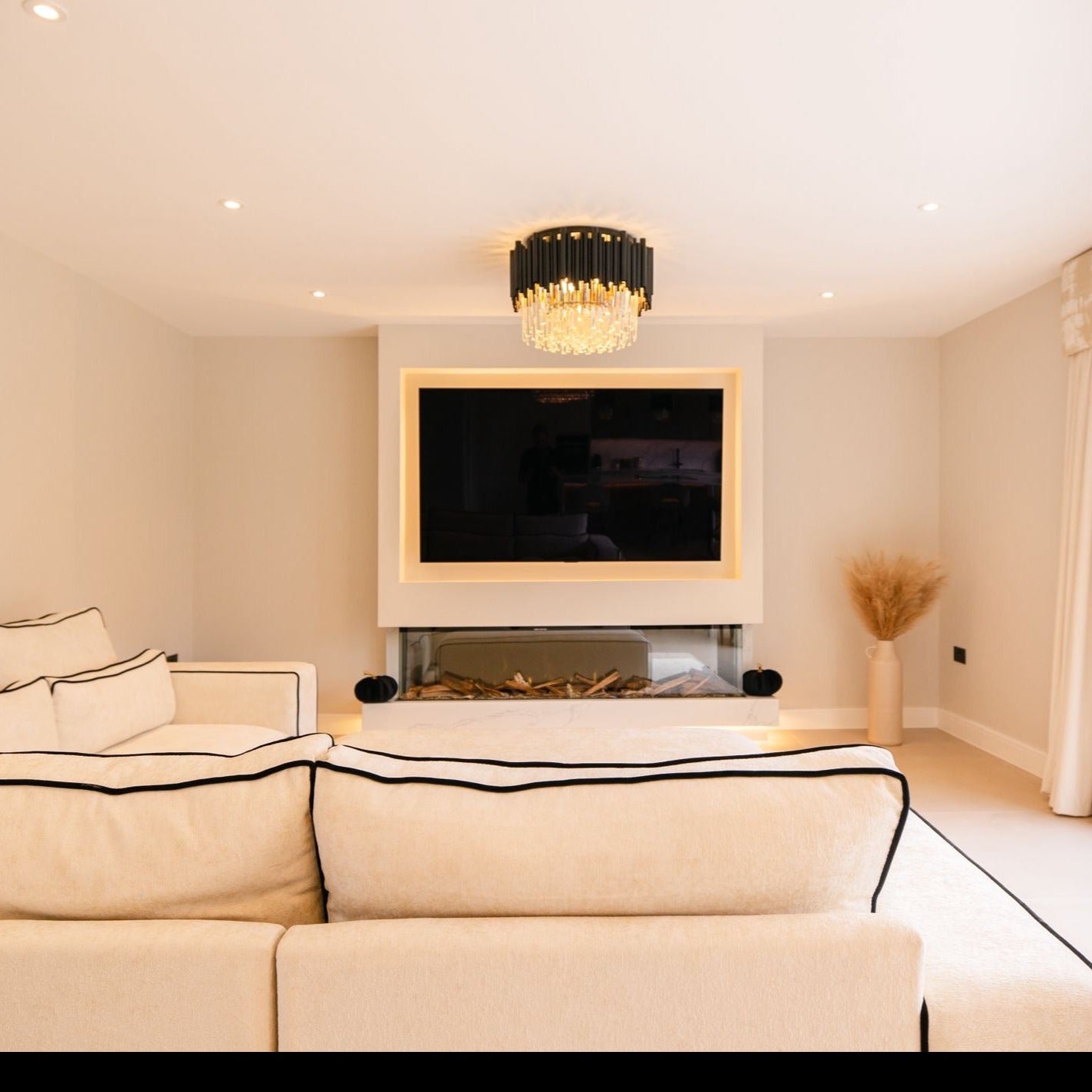 High-end Gotham ceiling light enhancing a refined modern lounge interior.