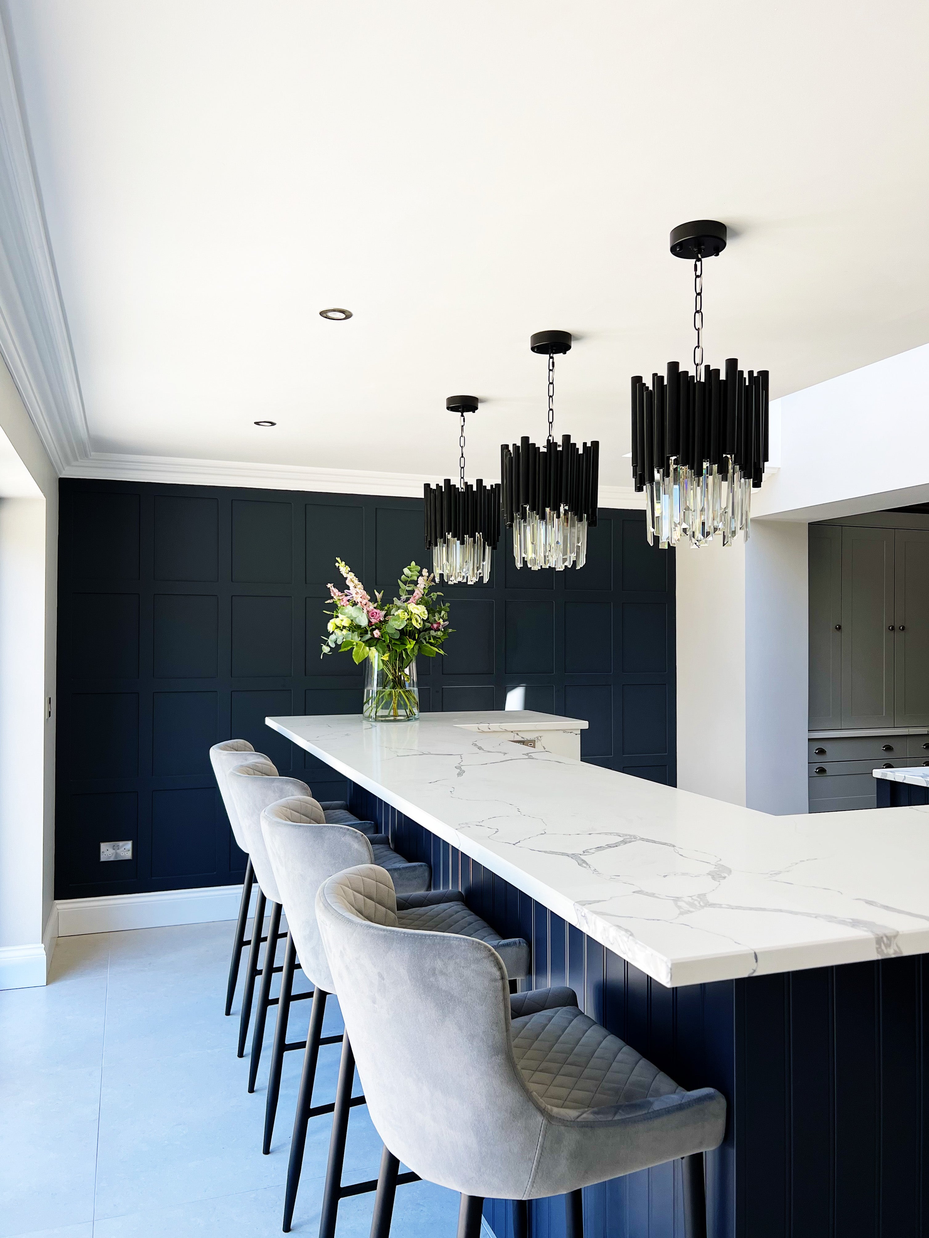 Multiple Gotham pendant lights installed above a kitchen island