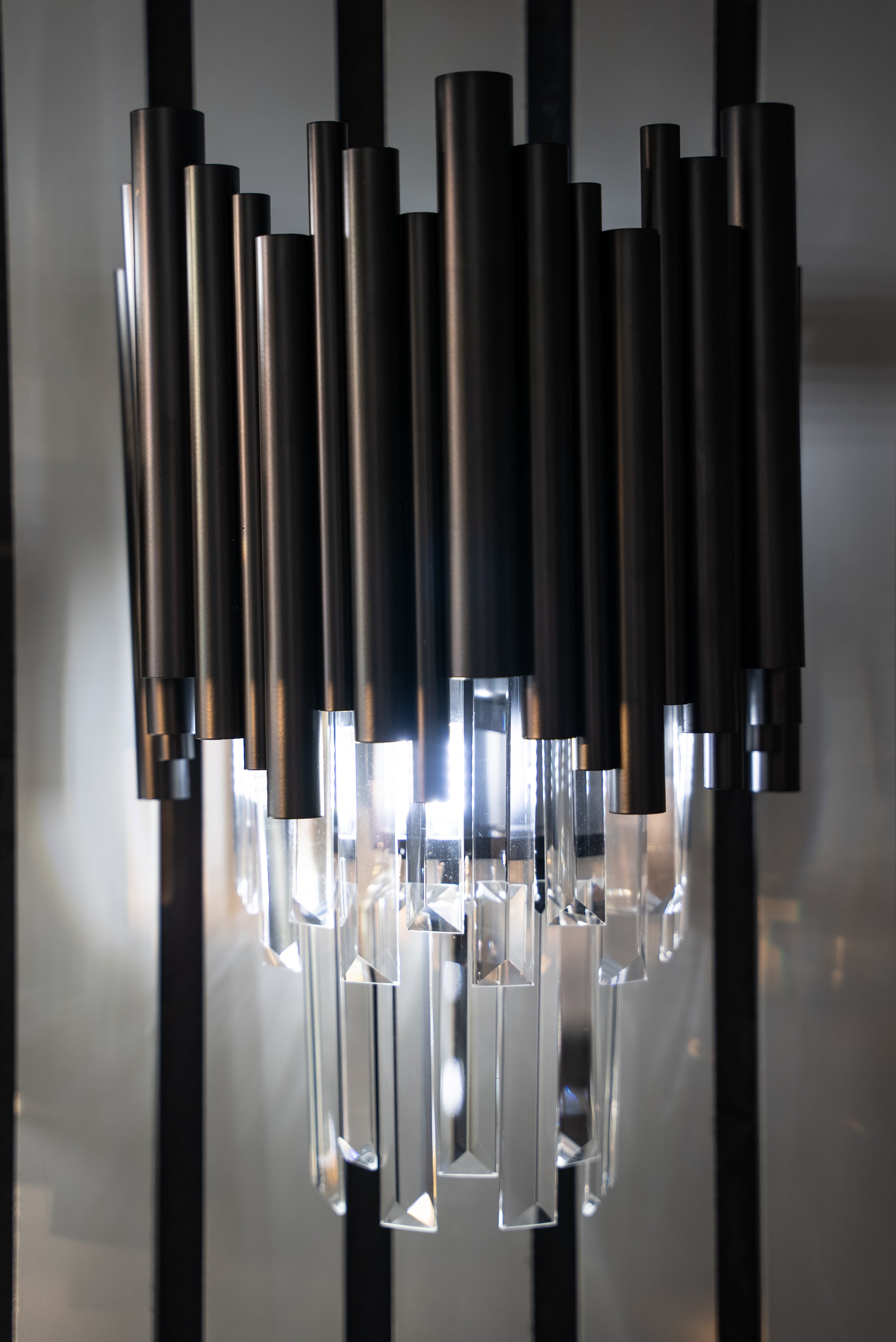 Gotham wall light shown vertically highlighting layered crystal bar arrangement