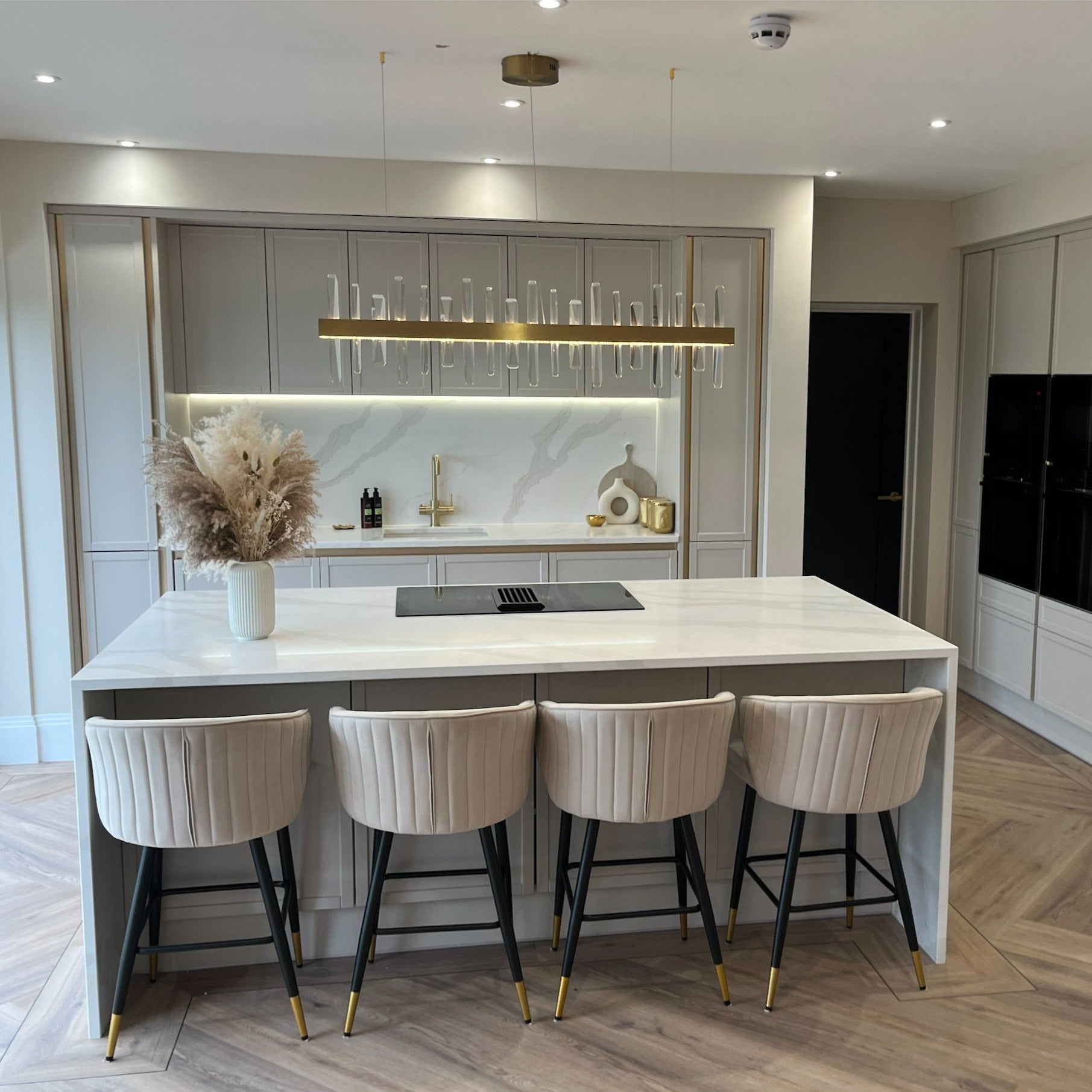 Grantchester Rectangular Chandelier positioned above a modern luxury kitchen island
