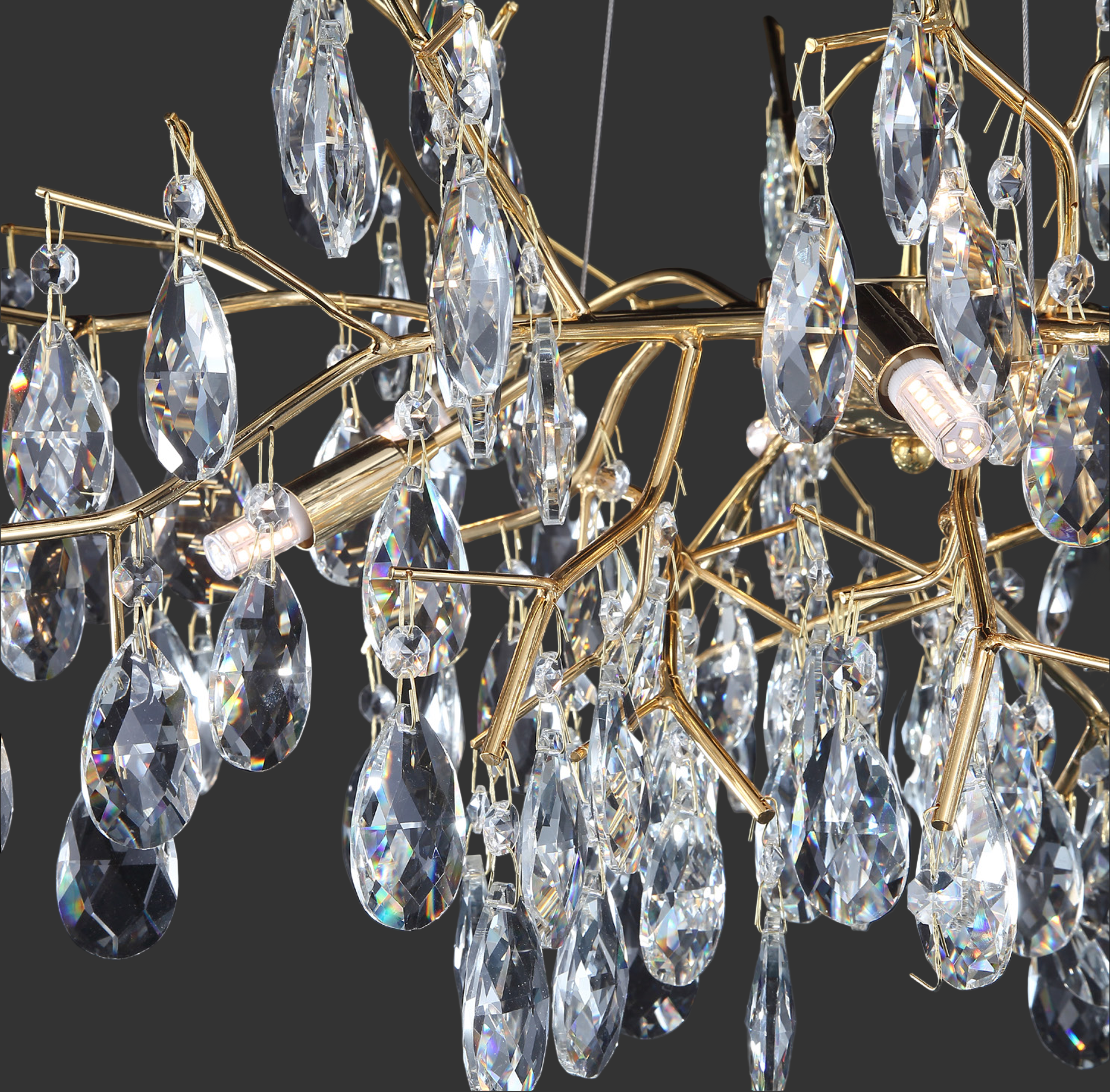Intricate patterns of light and shadow cast by the premium diamond-cut crystal elements of the Dewdrop luxury pendant.