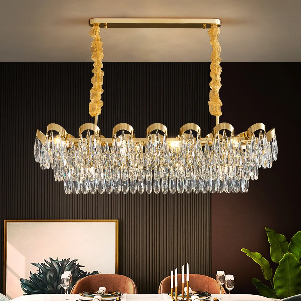 Isso Rectangular Chandelier with diamond cut teardrop crystals installed above a luxury dining table