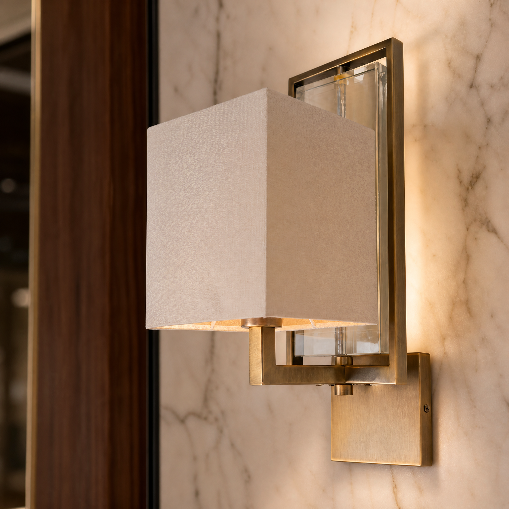 Macro shot of the Lioren wall light showcasing the intricate faceted crystal detailing and refined antique brass frame.
