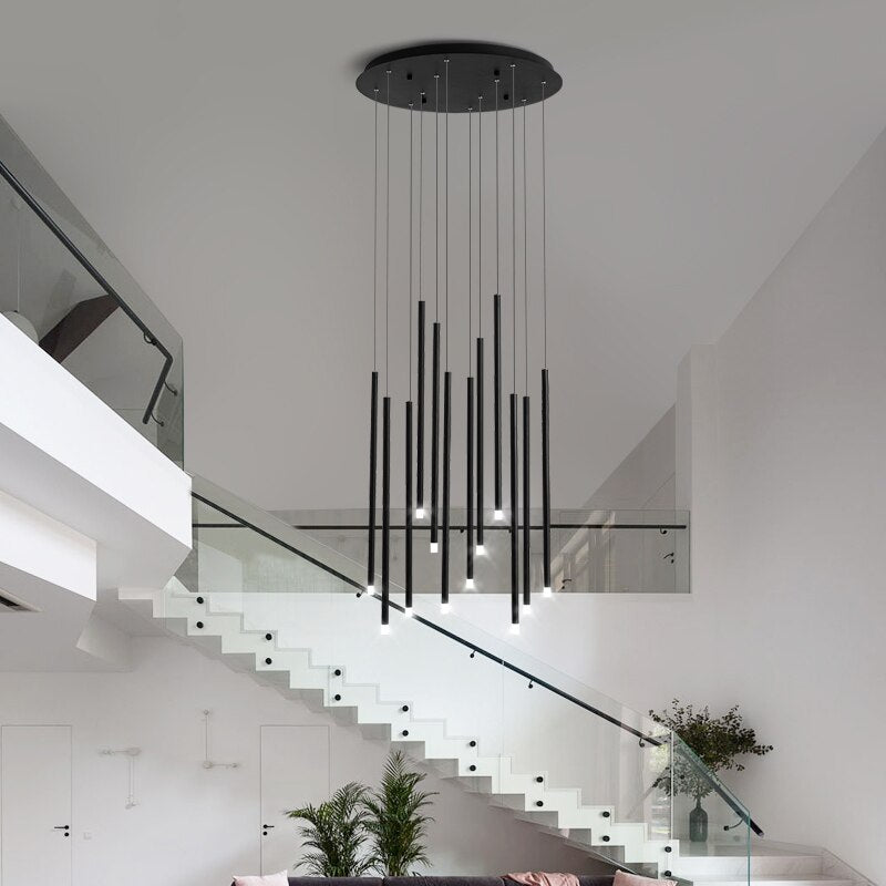 Liscio pendant staircase chandelier with cascading cylinder pendants in a modern stairwell