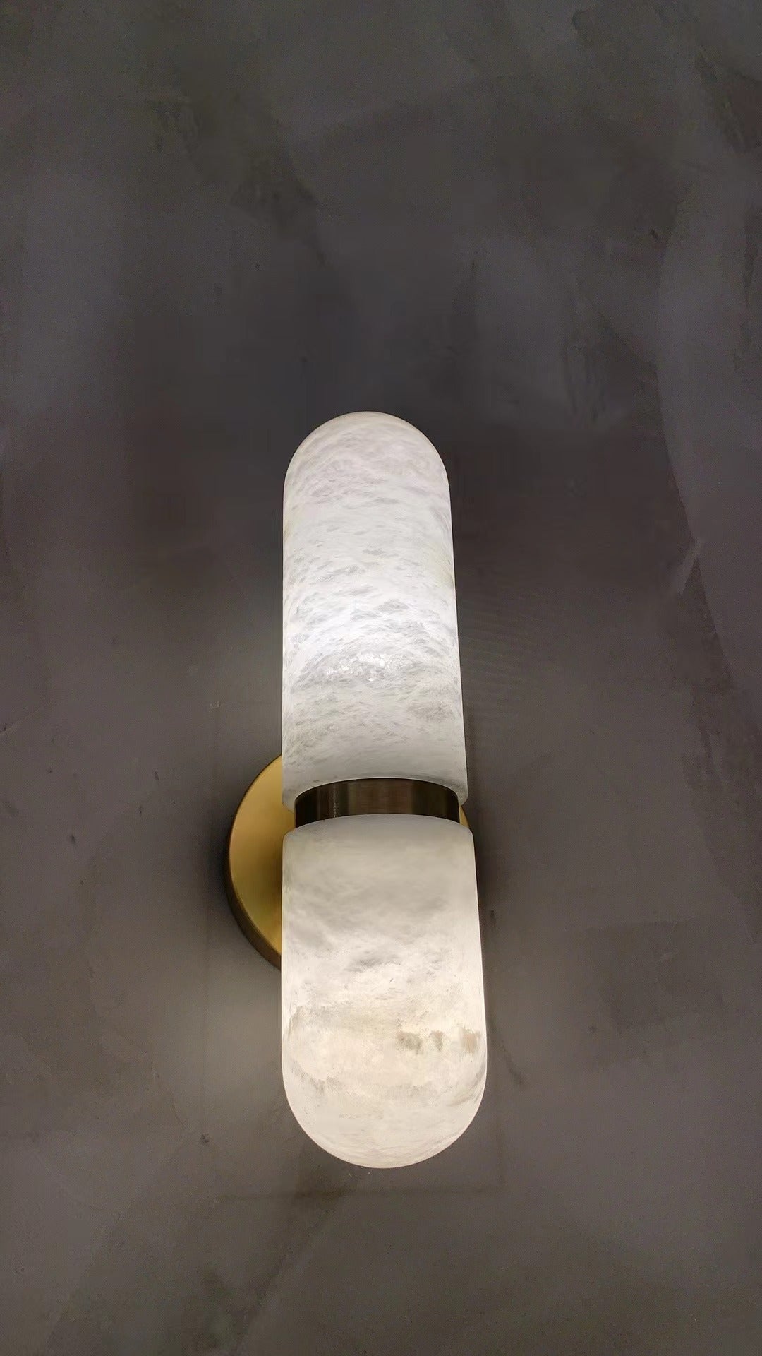 Vertical installation of Luma marble wall light on a contemporary interior wall