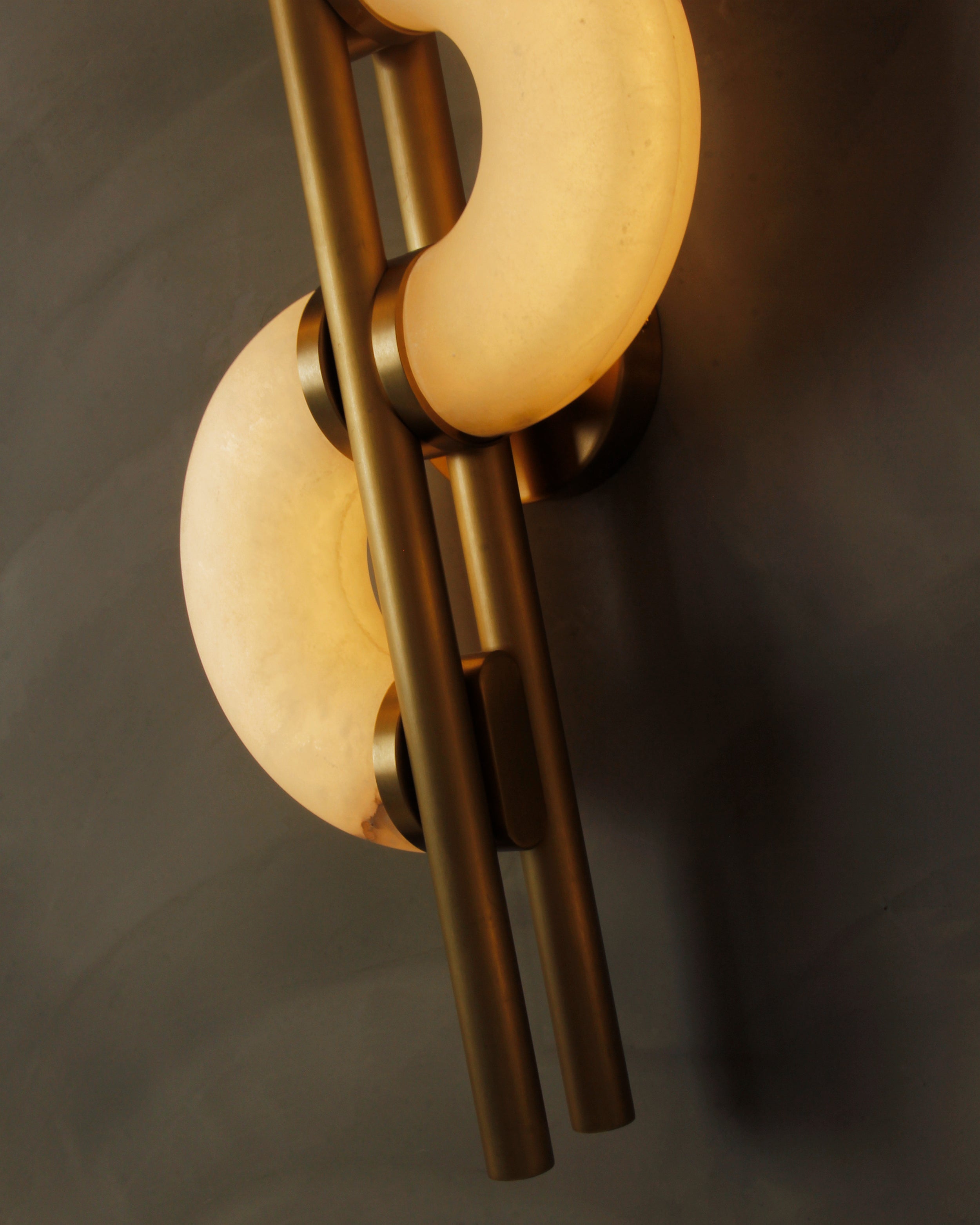 Lunaro marble wall light in a dark luxury interior showing sculptural marble glow