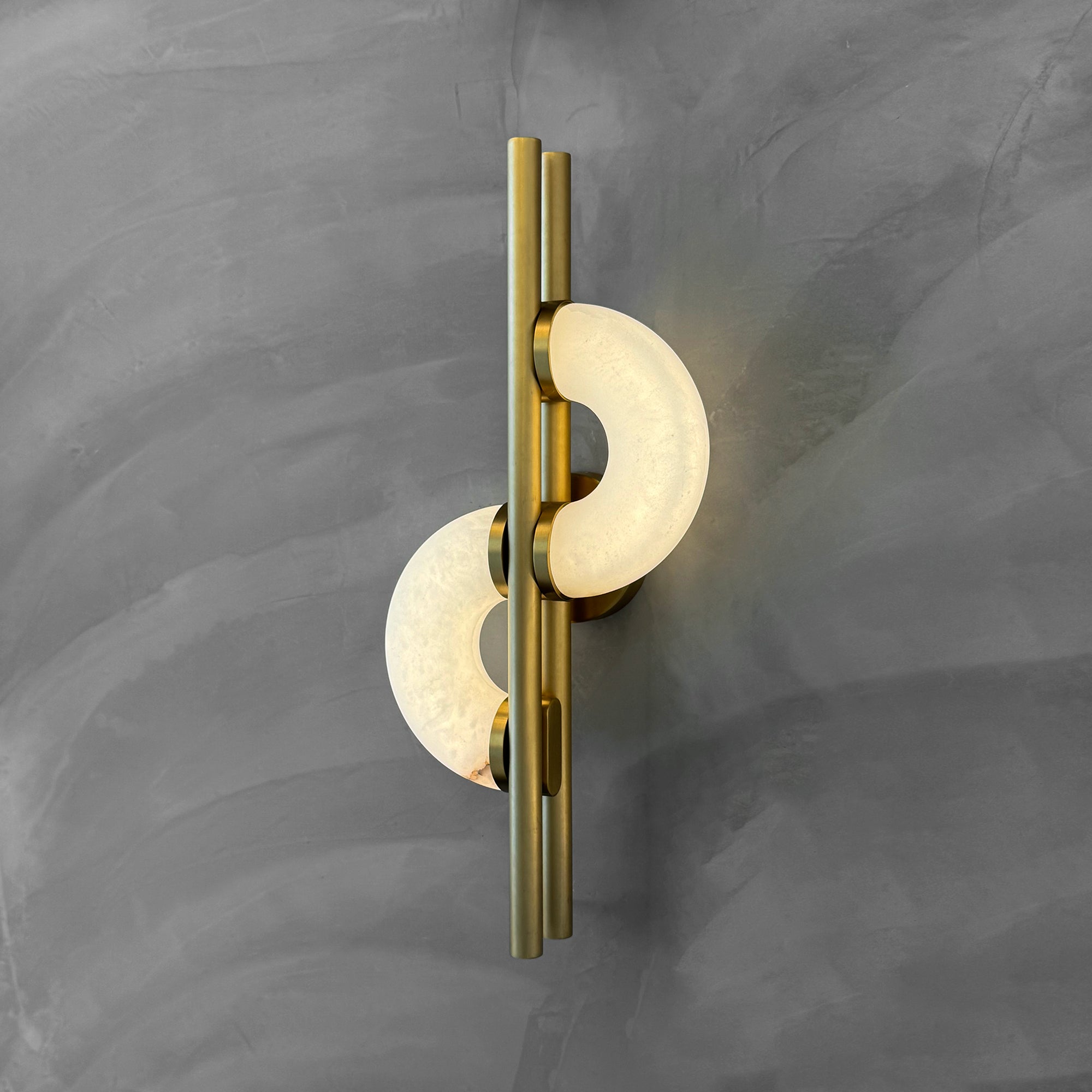 Lunaro marble wall light installed on a neutral textured wall in a luxury interior