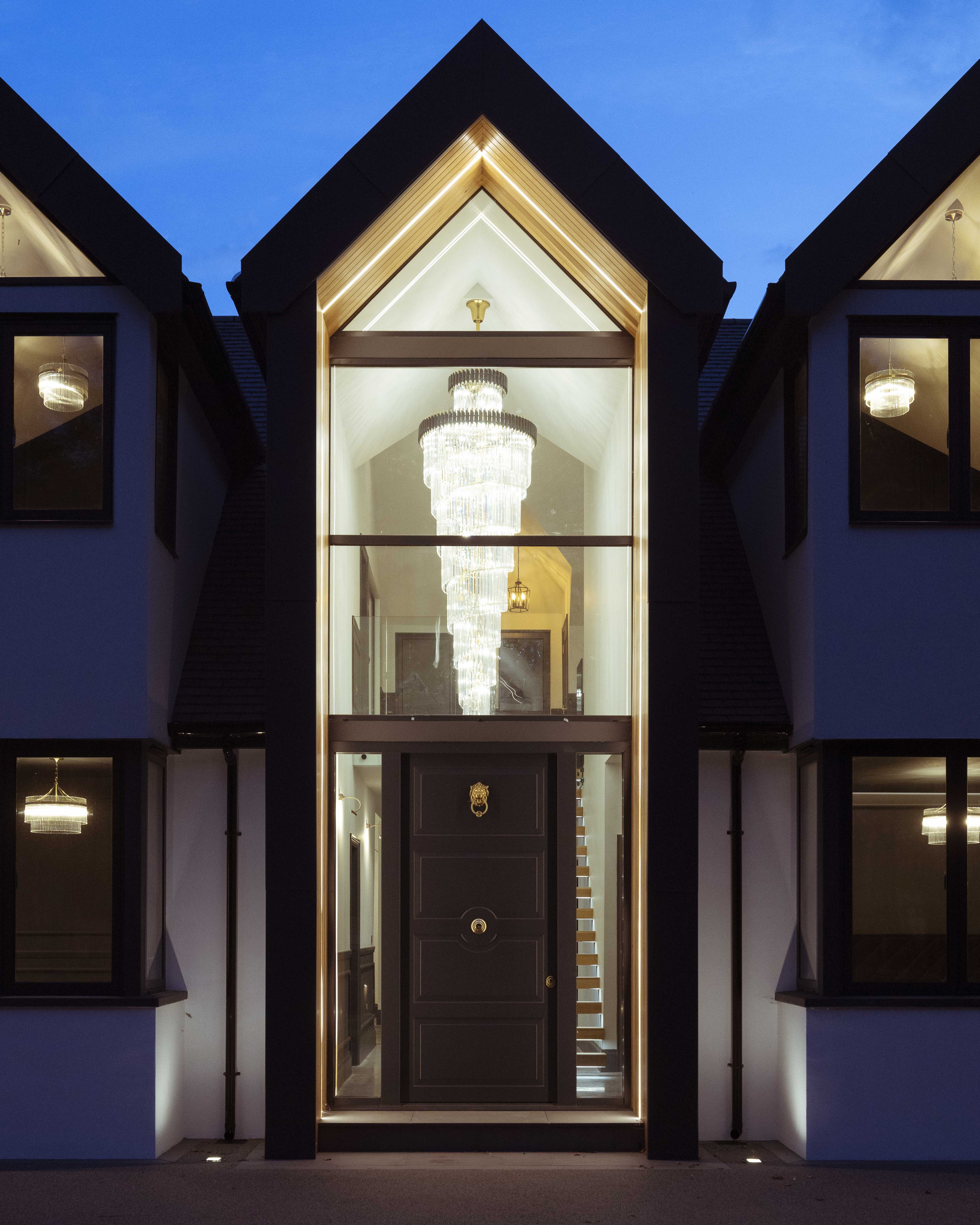 Luxury staircase chandelier in a double-height entrance hall, bespoke crystal lighting for grand stairwells by VORELLI®