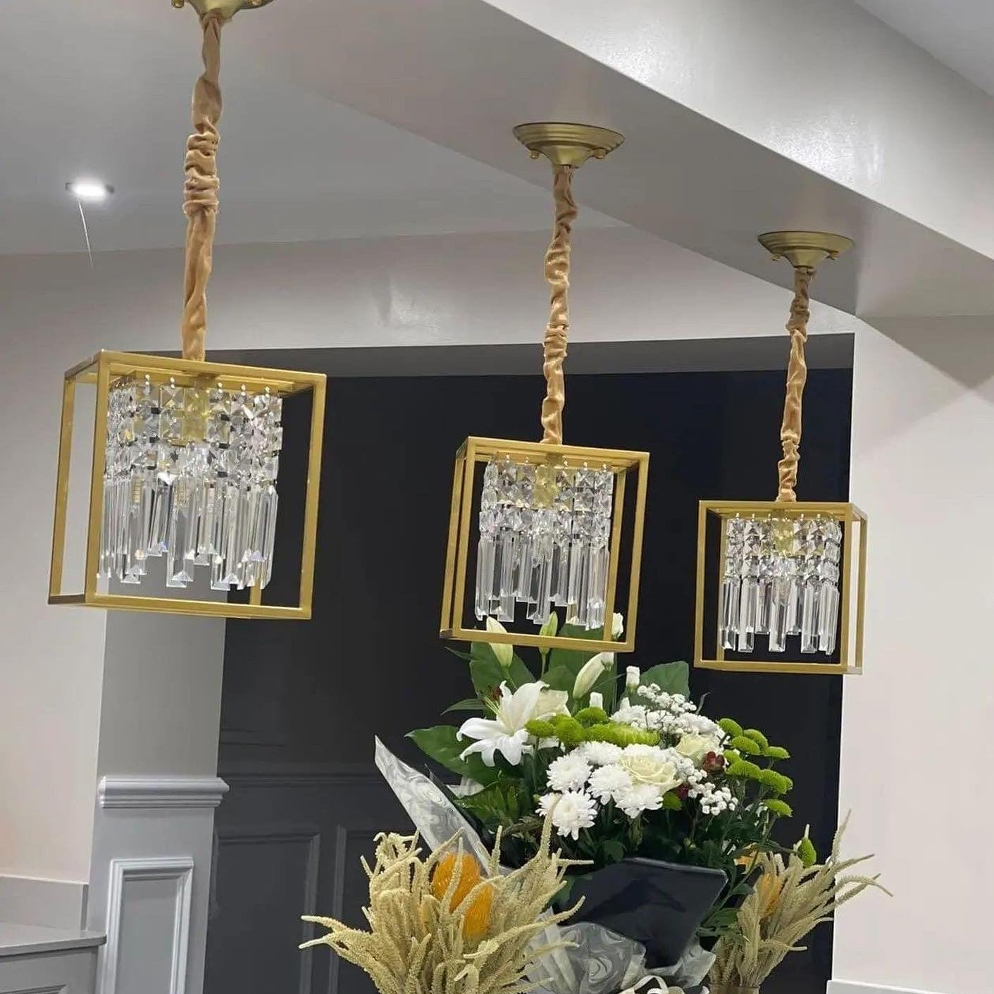 Three Maddison cube pendant lights suspended above a kitchen island