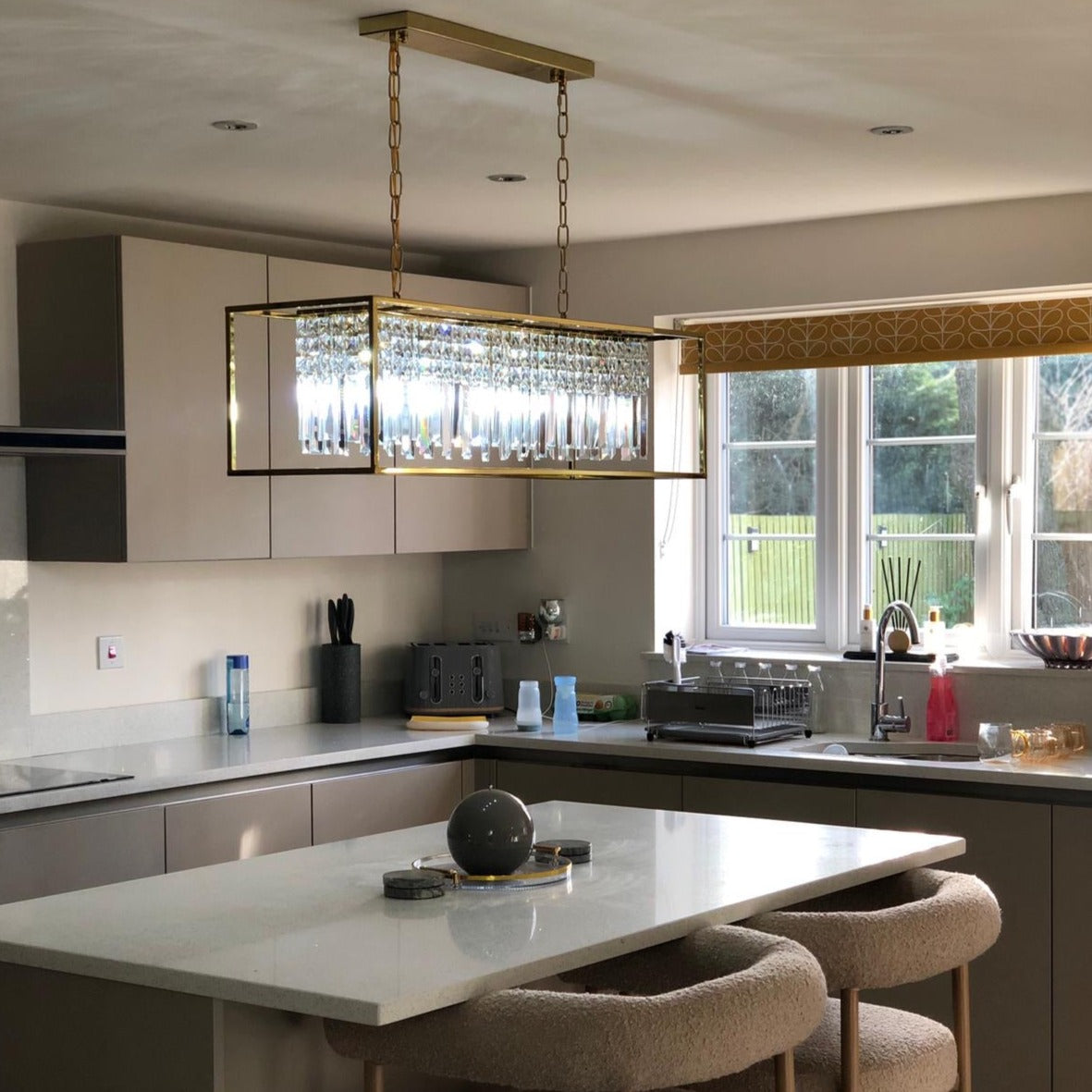 Maddison rectangular crystal chandelier suspended above a kitchen island