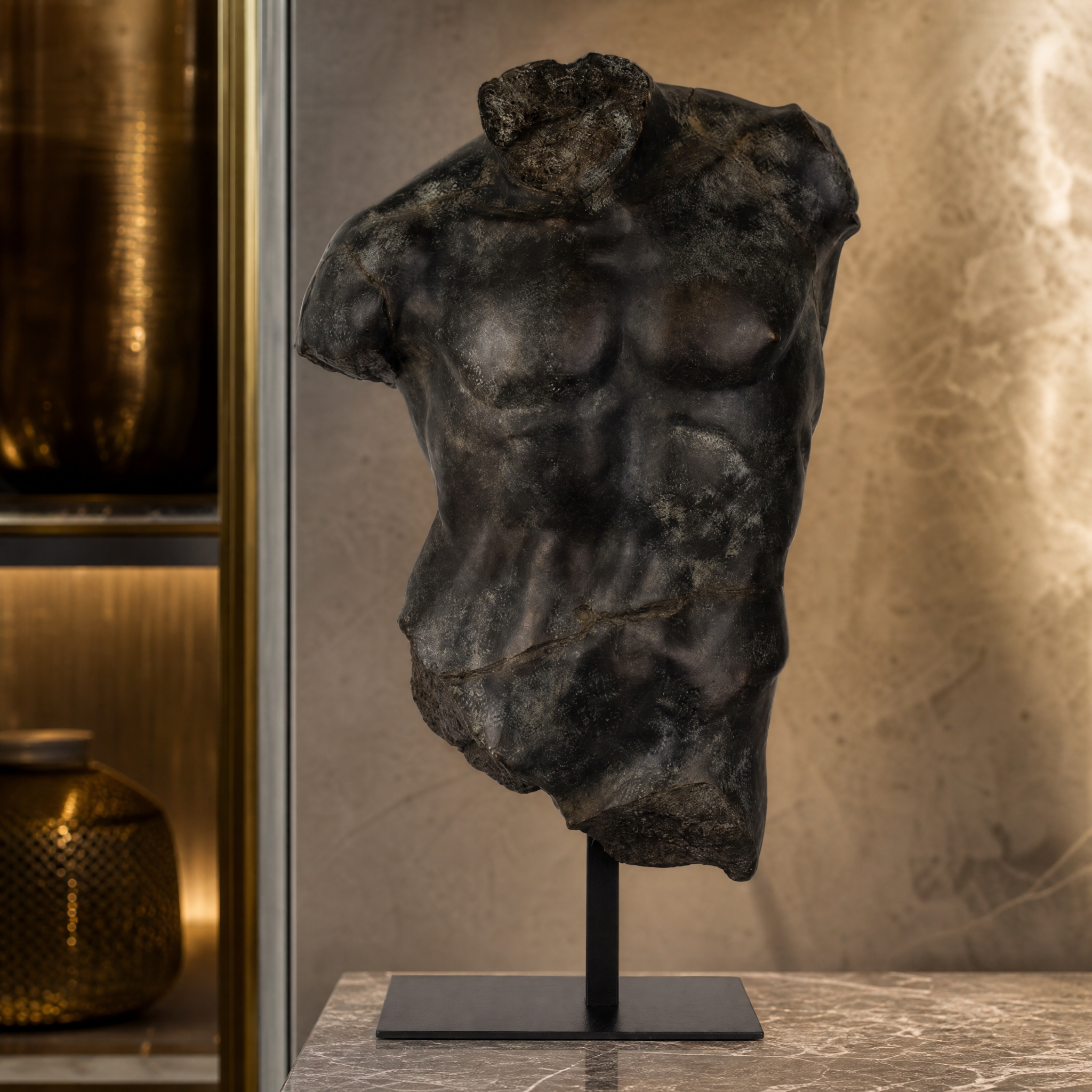 Macro view of the rich aged bronze tones and detailed polyresin craftsmanship on the Magnano Large Torso.