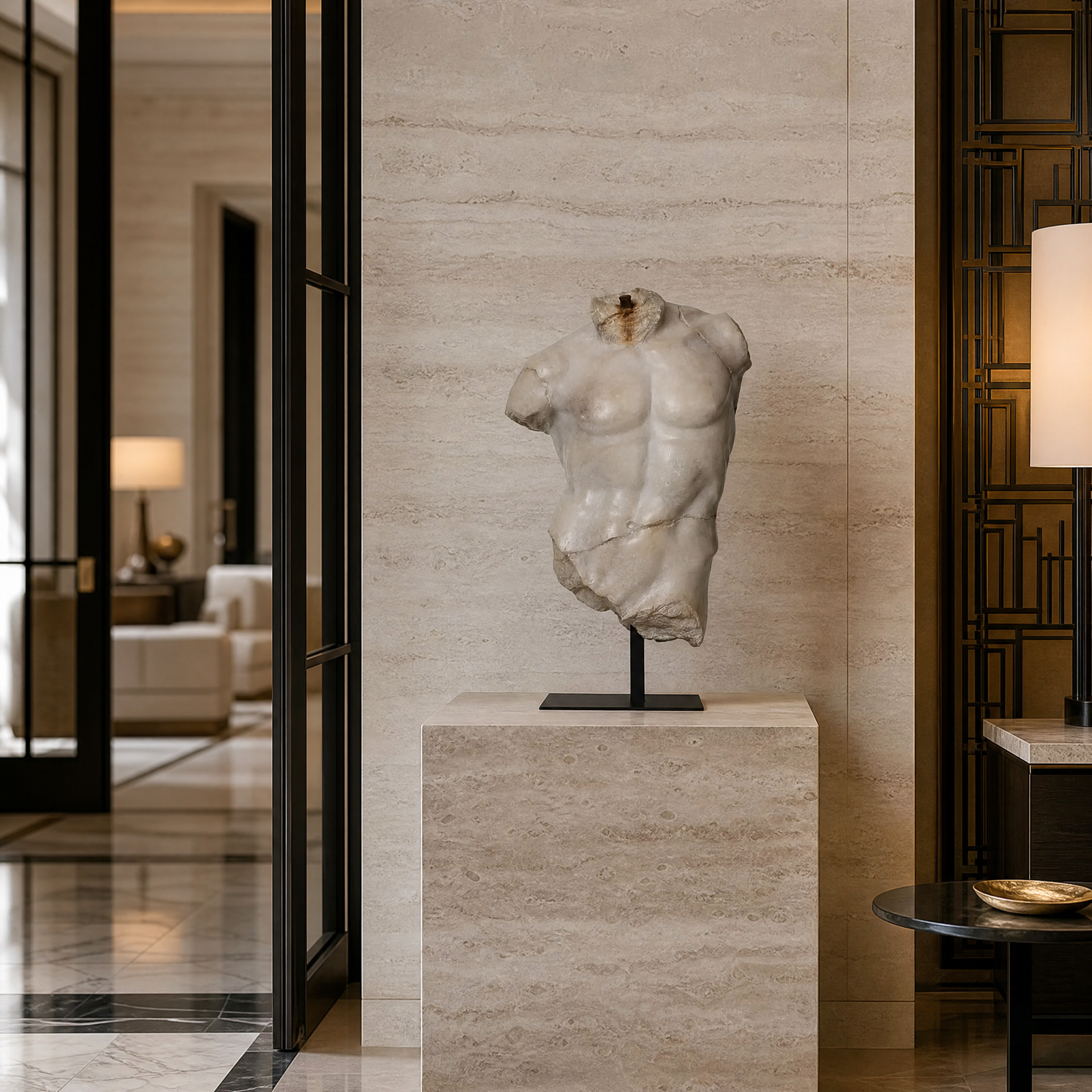 Magnano large torso decor showcased on a pedestal in a modern hospitality setting, featuring intricate sculptural detailing.