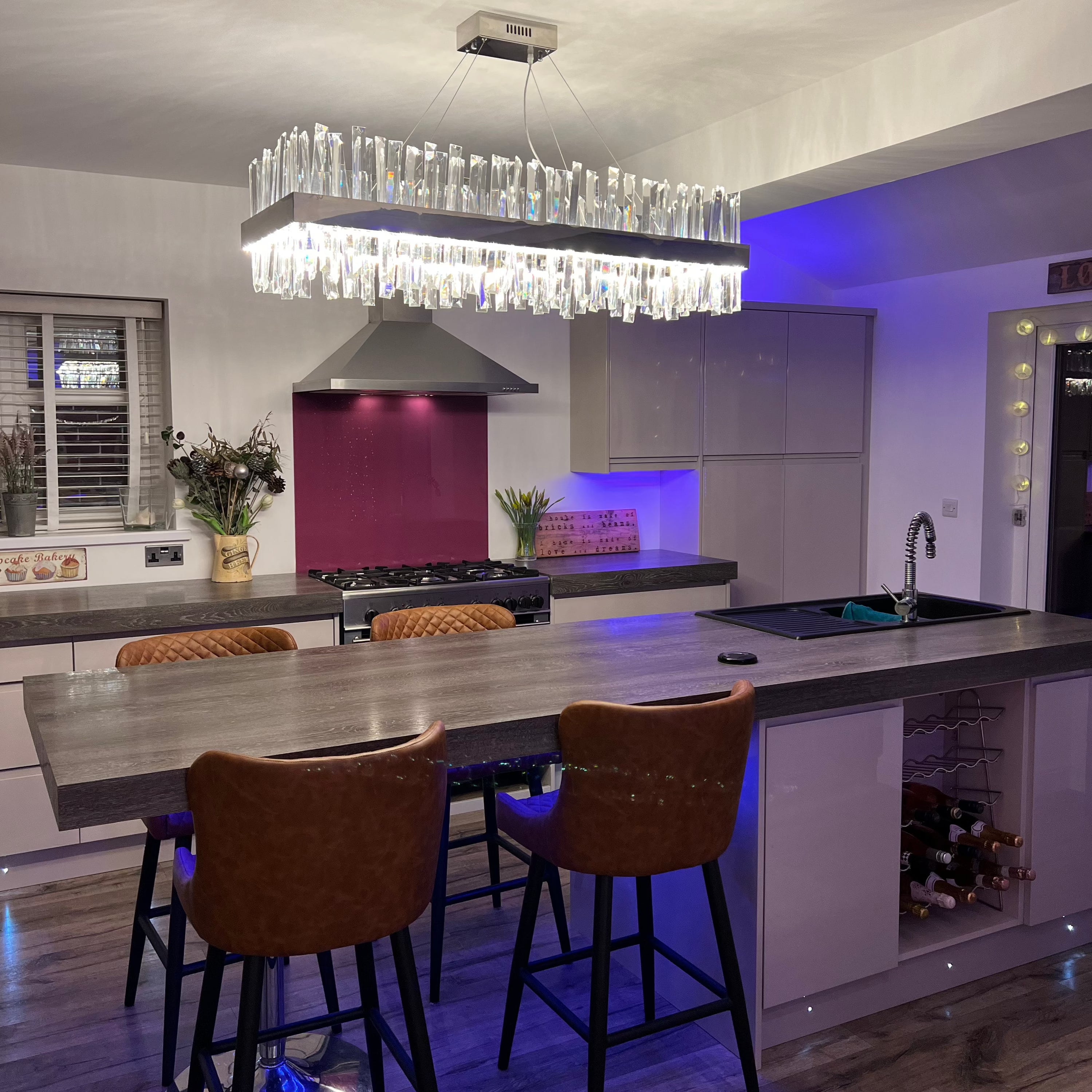 Rectangular crystal chandelier enhancing an open-plan kitchen and dining space with contemporary elegance