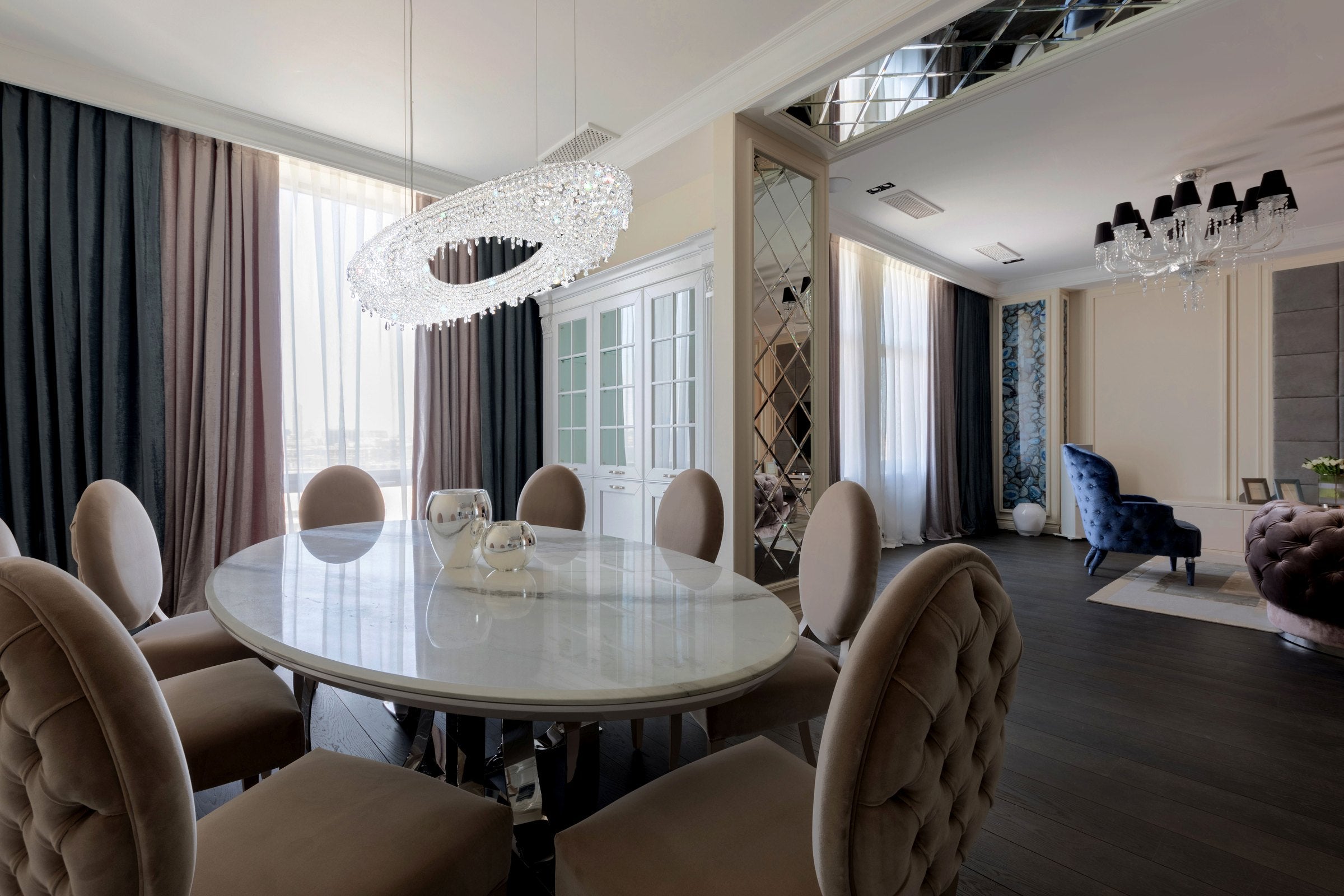 MANOOI Artica crystal chandelier above a dining table in a luxury residential interior