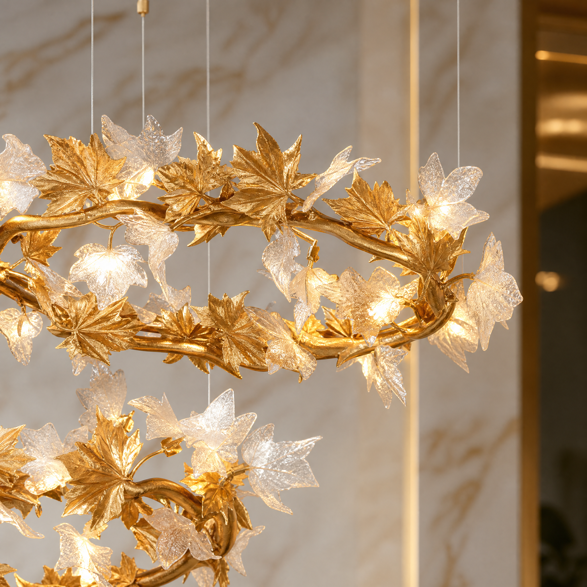 Macro closeup of the intricate sculptural metal leaves and softly diffused lighting elements on the VORELLI Maple Grove circular chandelier.