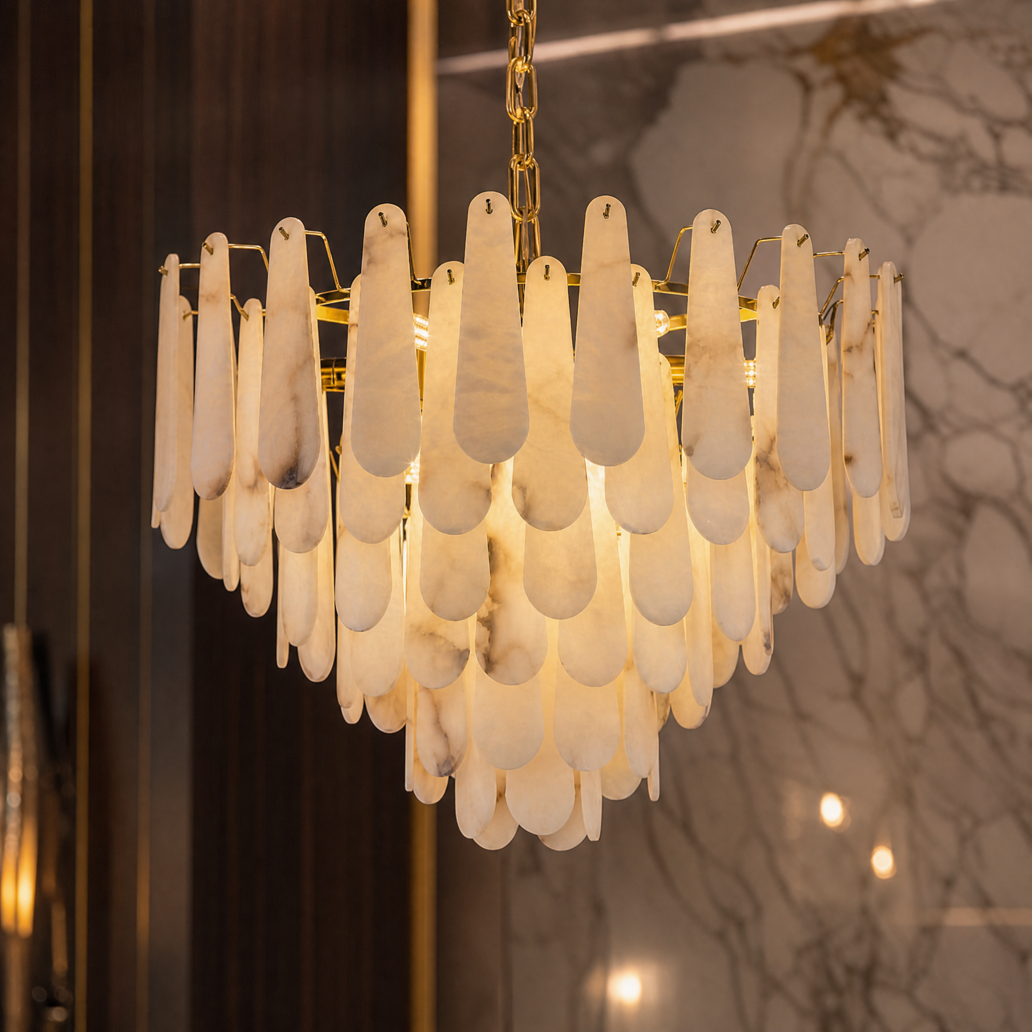 Close-up detail of the cascading layers of premium marble on the VORELLI Maretto circular chandelier showcasing timeless luxury texture.