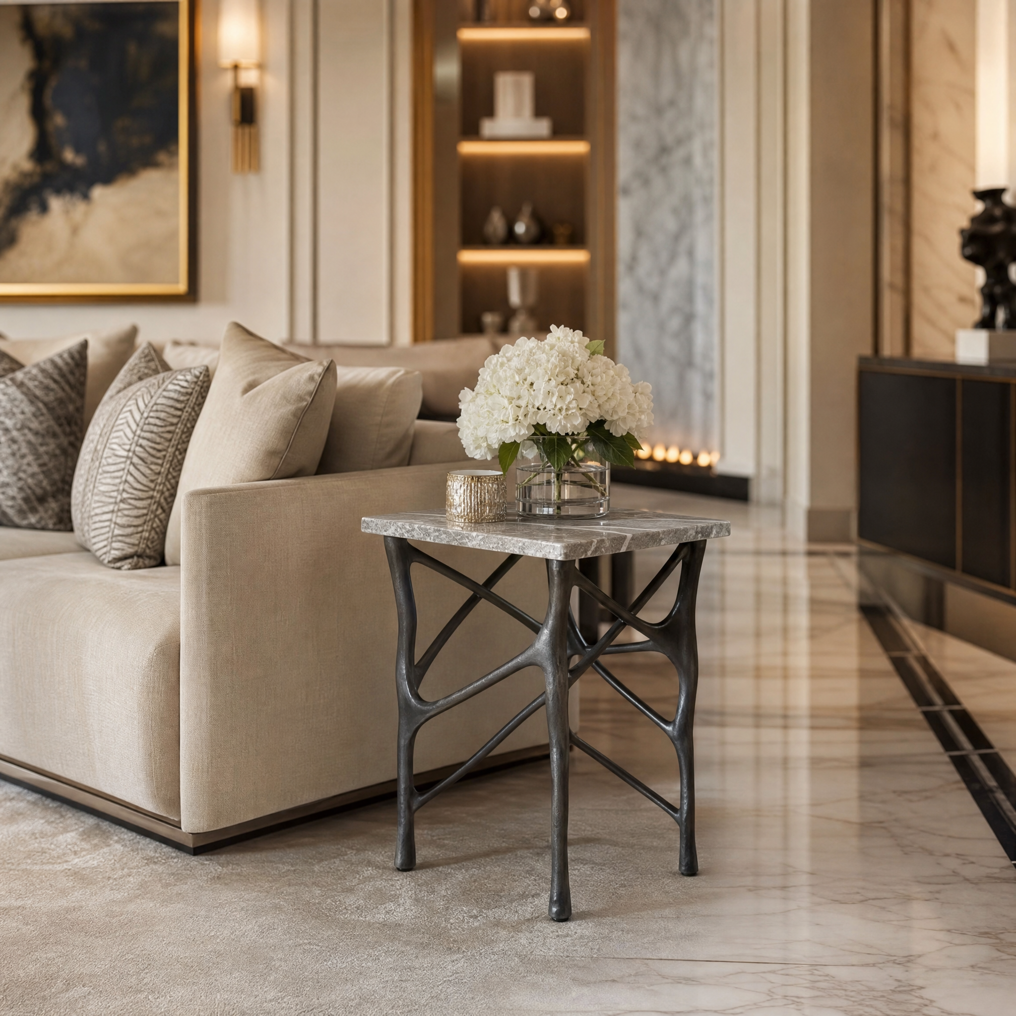 A modern living room setting featuring the Merano grey marble side table next to a sofa.