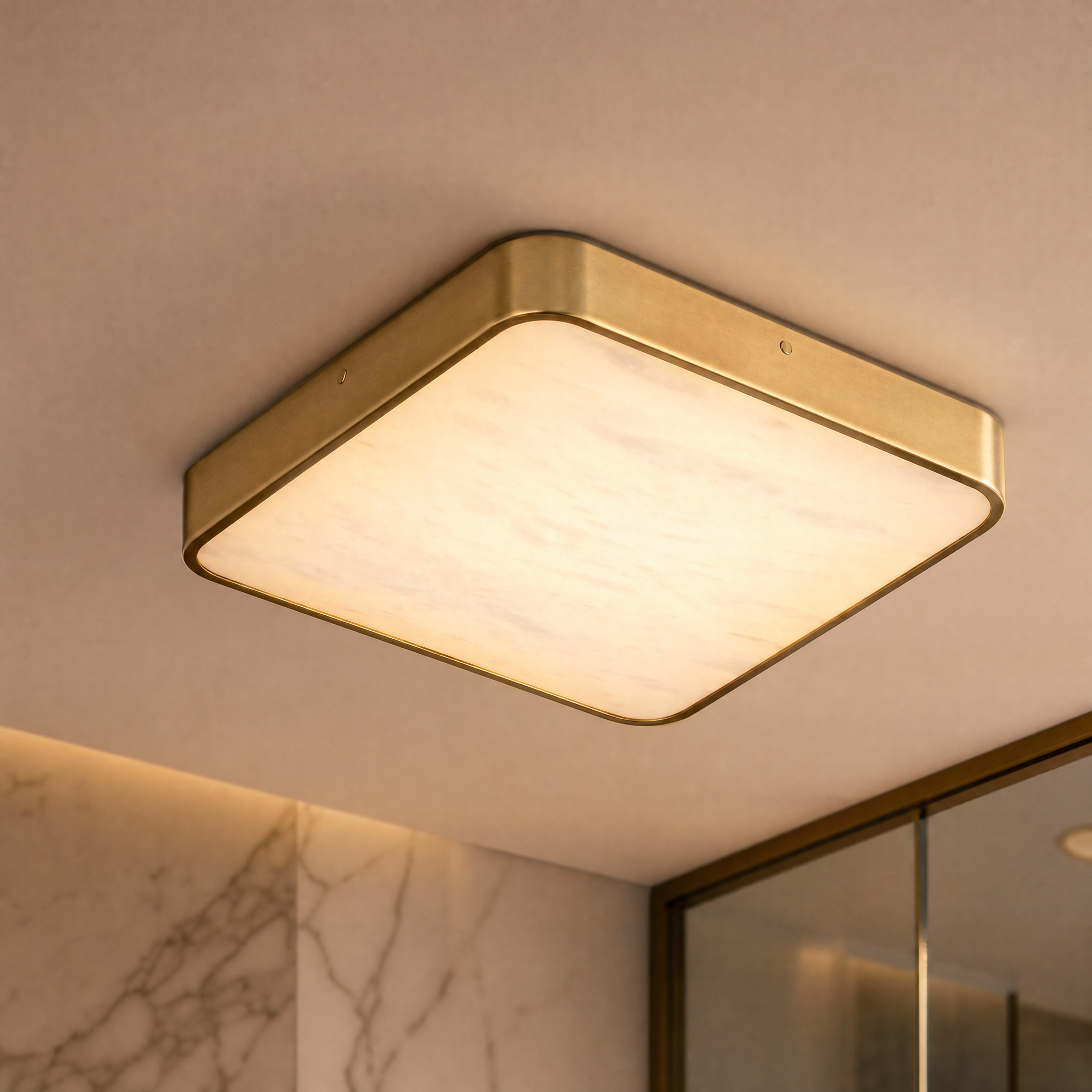 Close up detail of the brushed gold frame and natural marble diffuser of the Morenita ceiling light