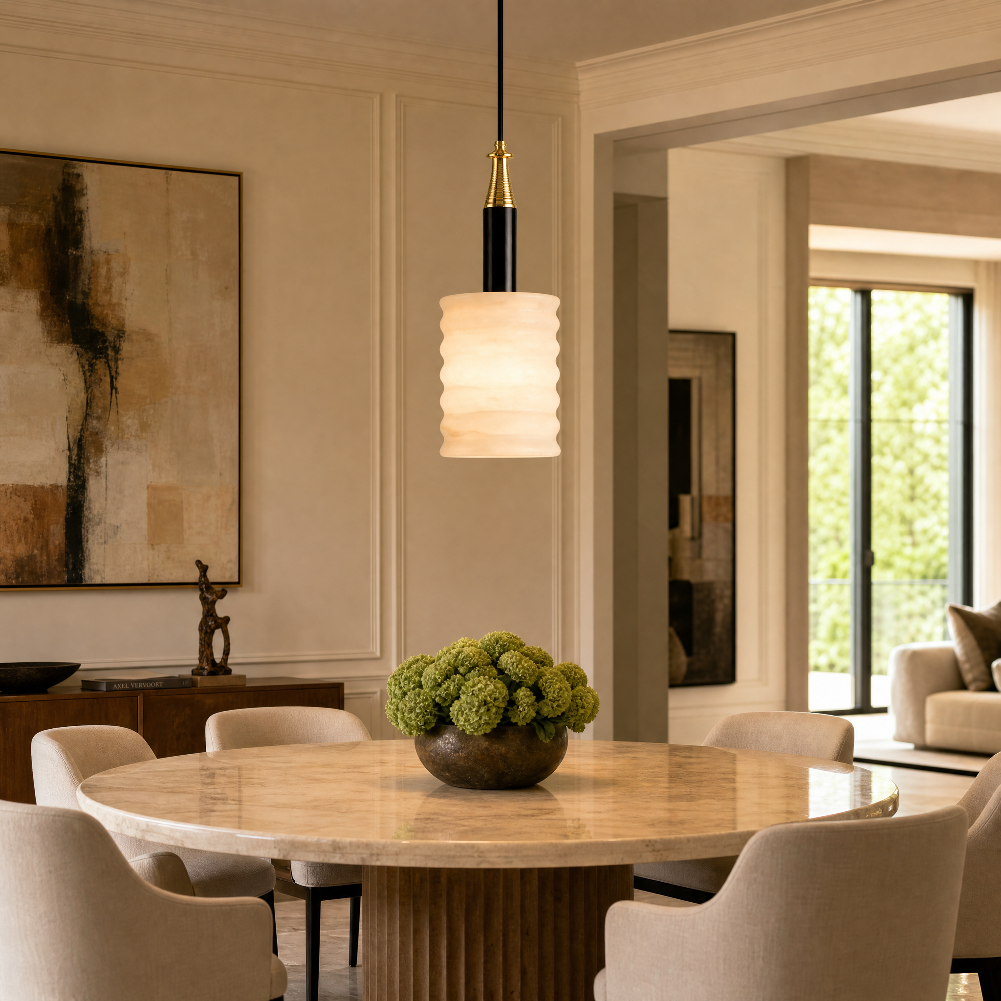VORELLI Noto marble pendant light hanging in a luxury residential living room, casting a warm glow over upscale contemporary decor.