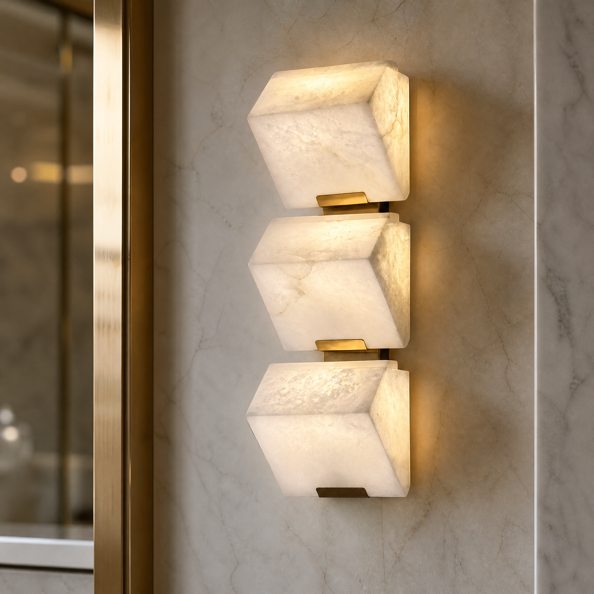 A detailed closeup of the Novara Marble Wall Light III showcasing the natural veining of the angular marble blocks and the integrated warm LED illumination.