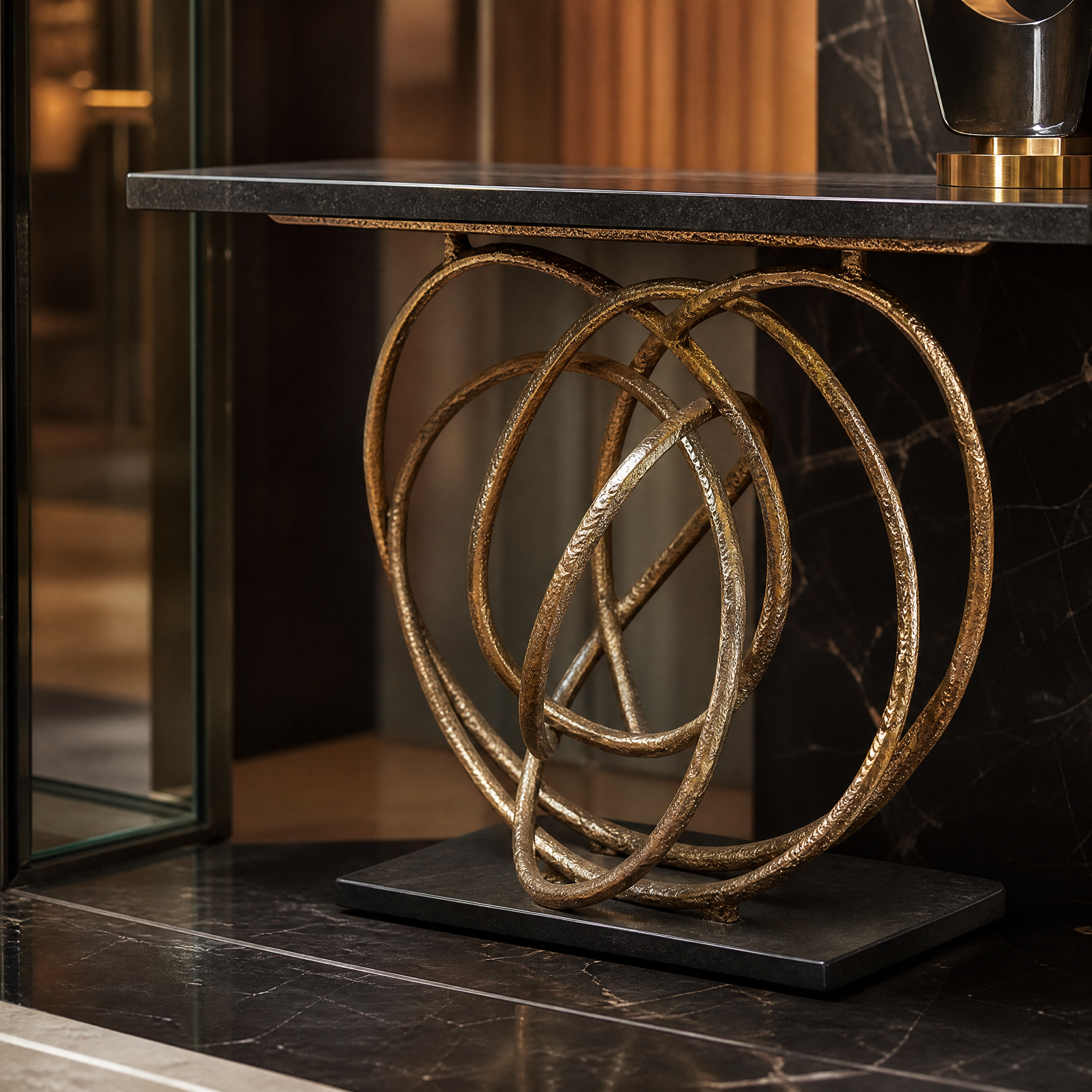 Detailed closeup of the bold brass frame and deep black surface contrasting on the VORELLI Orlano console table.