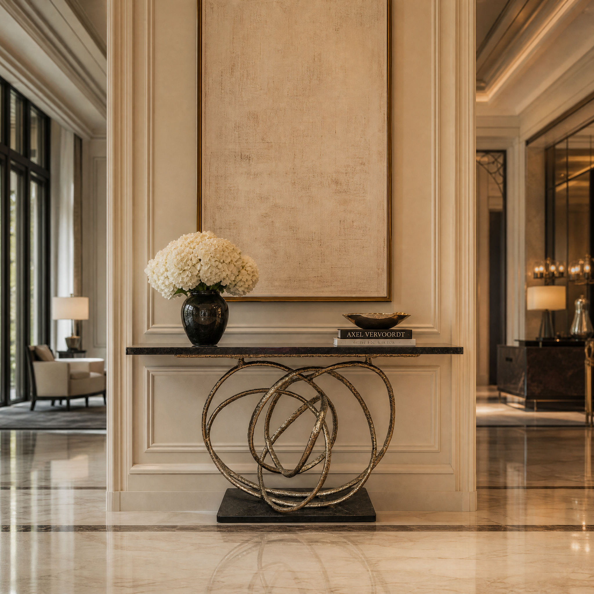 The Orlano brass frame black surface console table commanding attention in a sophisticated hotel lobby or hospitality setting.