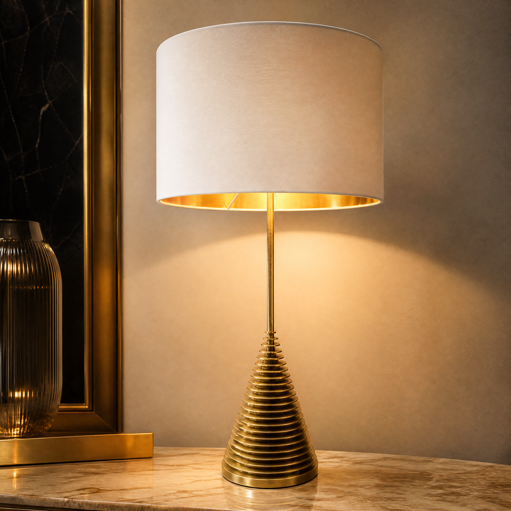Detailed closeup of the Orviano table lamp showcasing the striking visual texture of its sculptural tiered brass base.