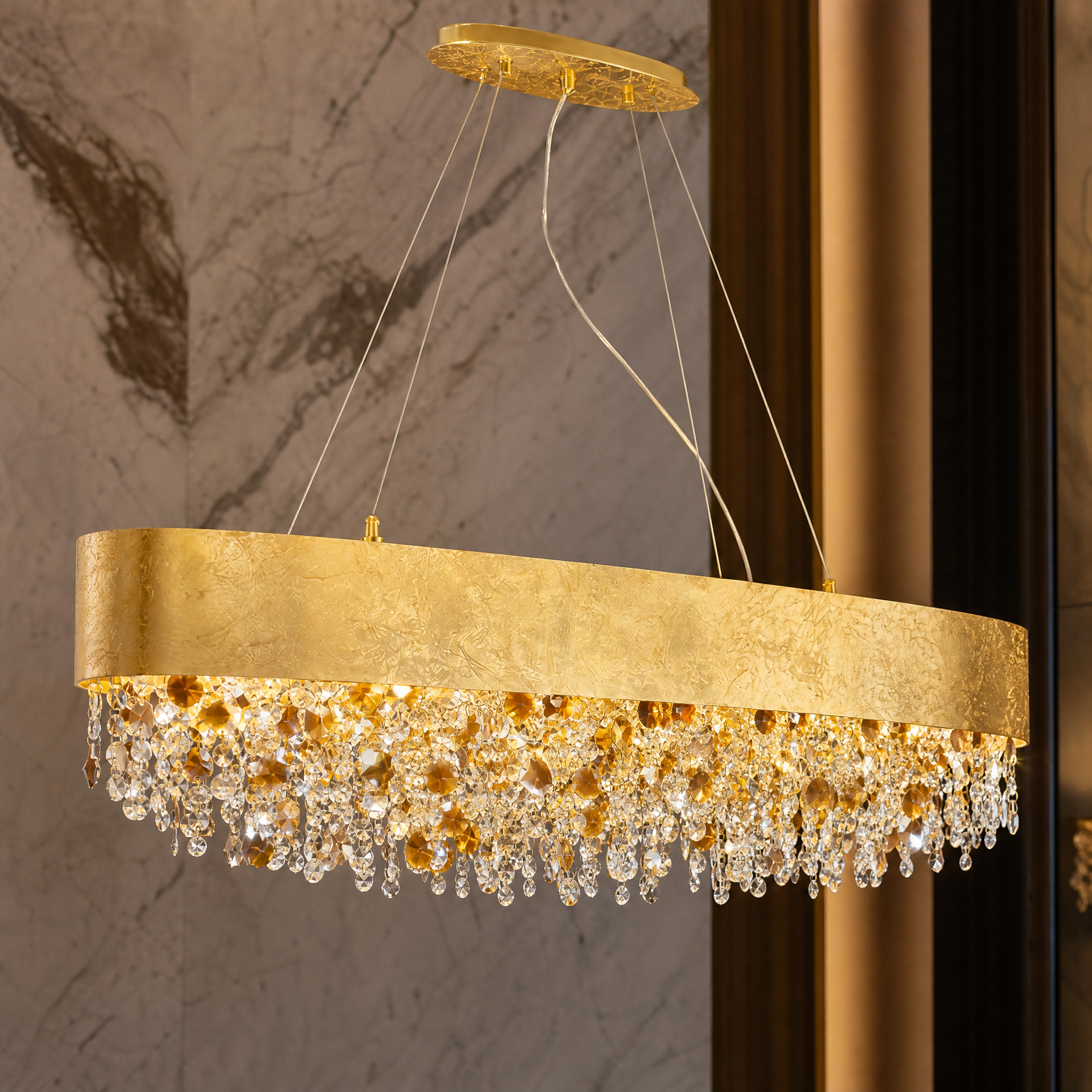 Close up detail of the VORELLI Owensboro chandelier showing the textured gold foil finish and layered octagon crystal chains