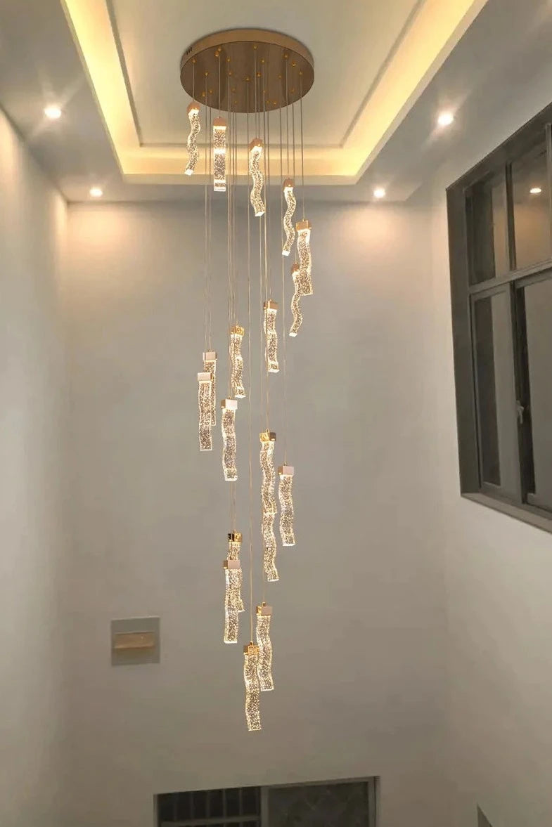 Modern crystal stairwell lighting design featuring the VORELLI® Palazzo pendant chandelier with elegant suspended illuminated forms