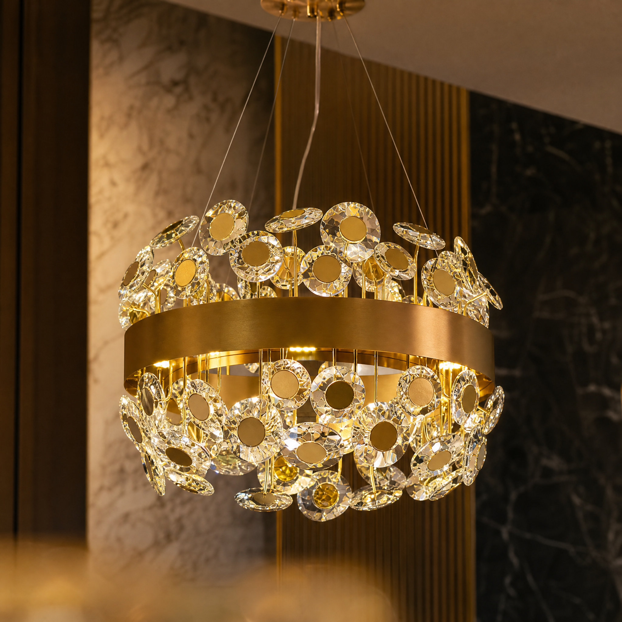 Close-up macro shot of the diamond-cut crystal discs and stainless steel frame of the Patara circular chandelier.