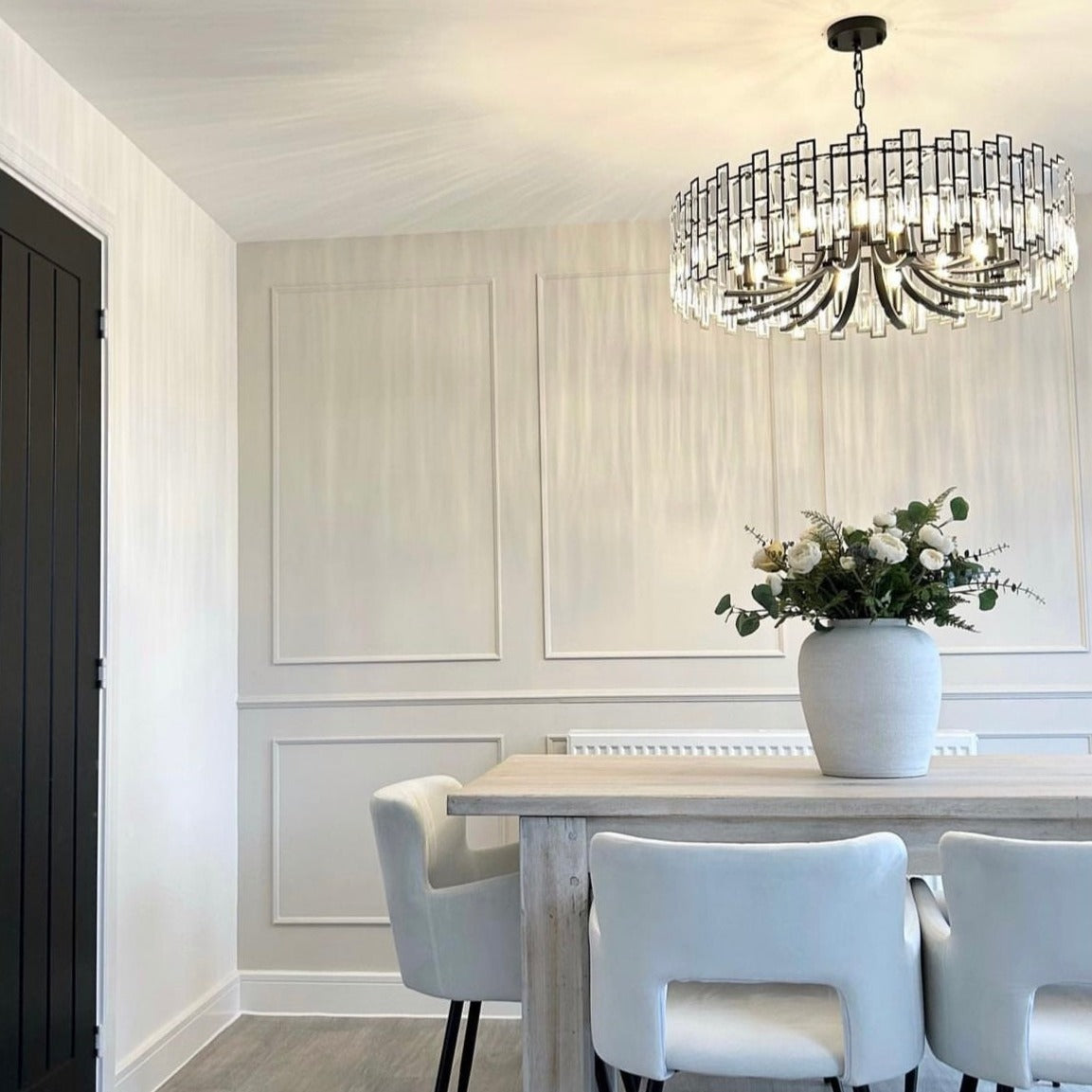 Presidio Circular Chandelier II suspended in contemporary open space creating elegant ambient glow