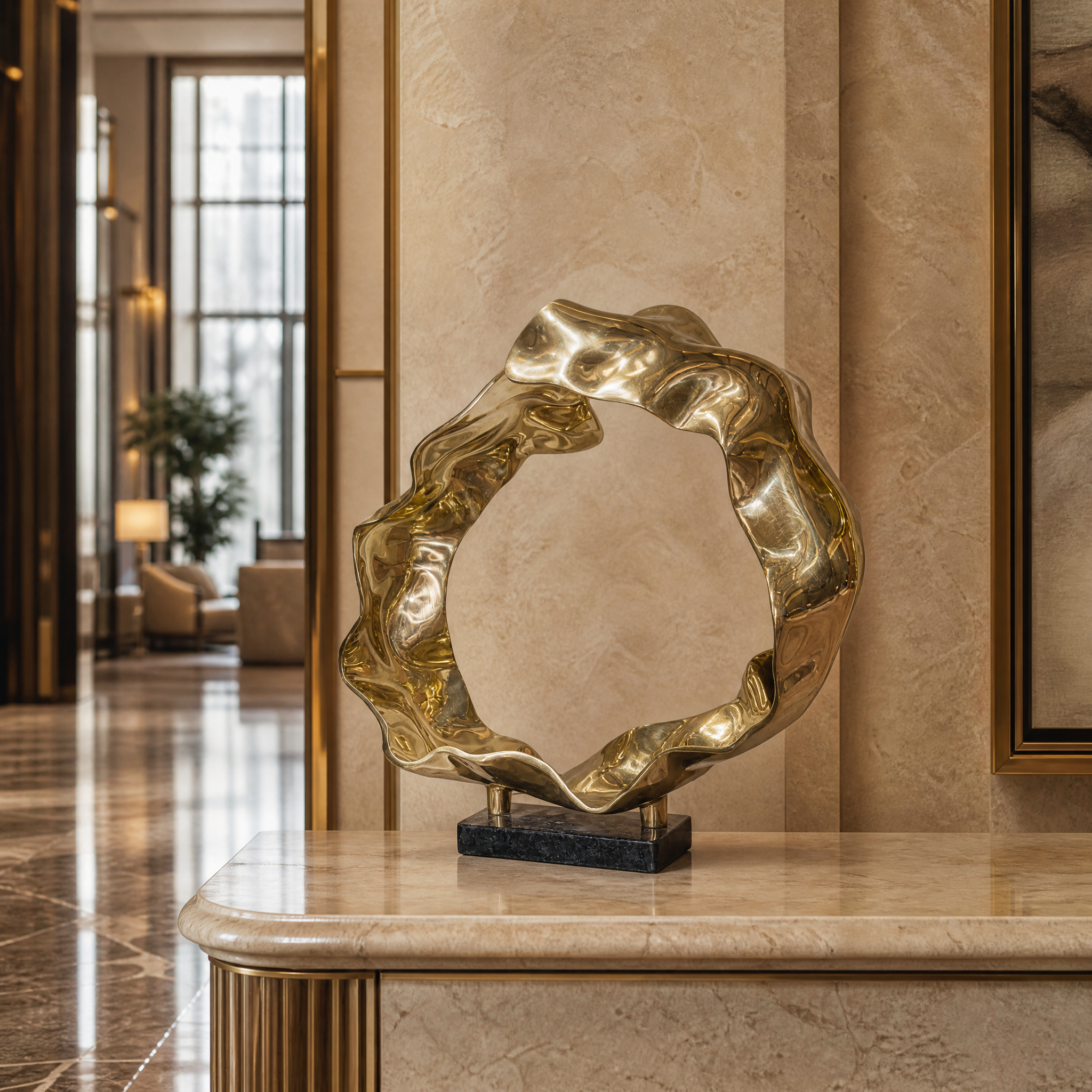 Luxury hospitality setting featuring the VORELLI Sartori gold wave sculpture as a sophisticated centerpiece in a hotel lobby.