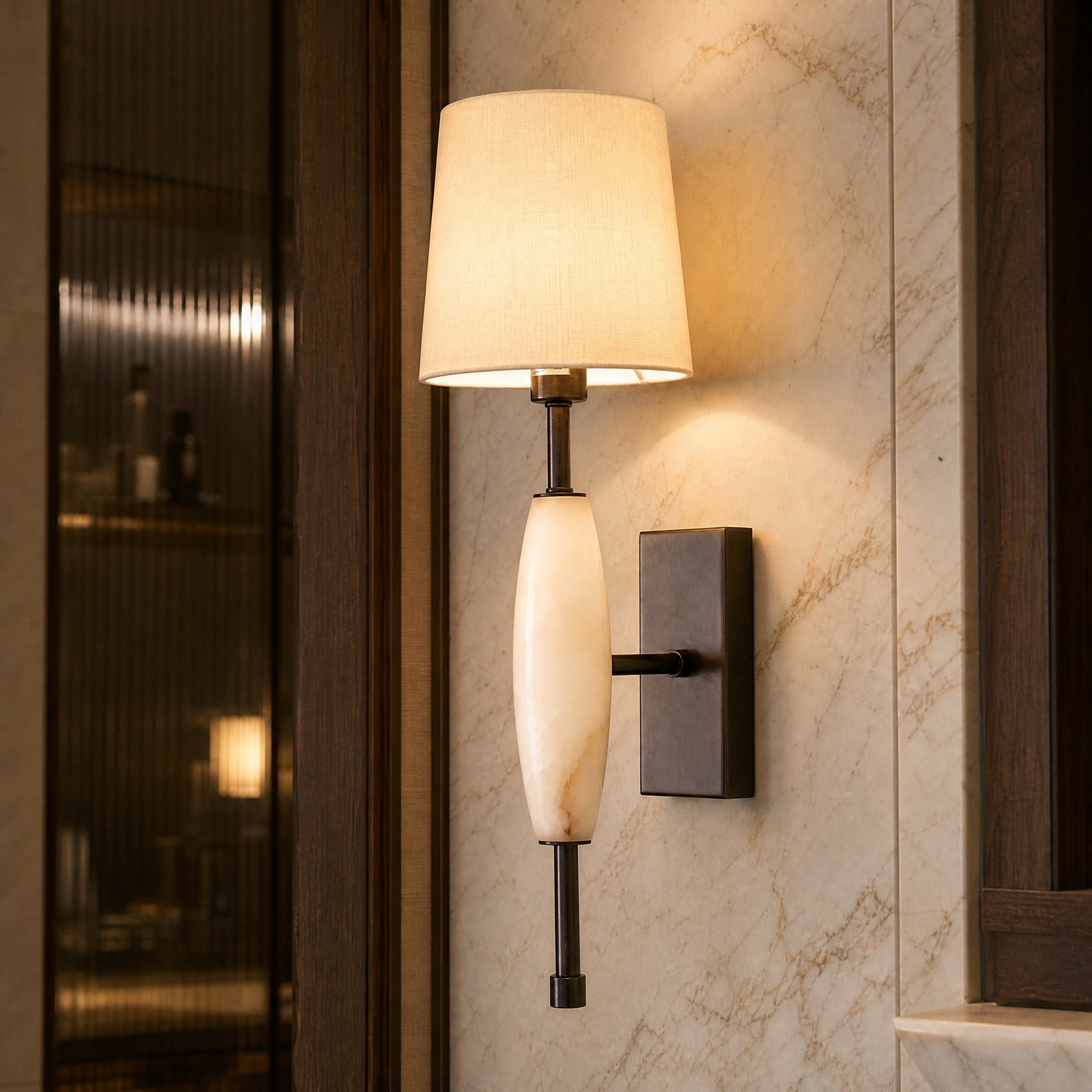 Close-up detail of the Seravine wall light showcasing the rich texture of the dark bronze frame, smooth natural alabaster, and refined fabric shade.