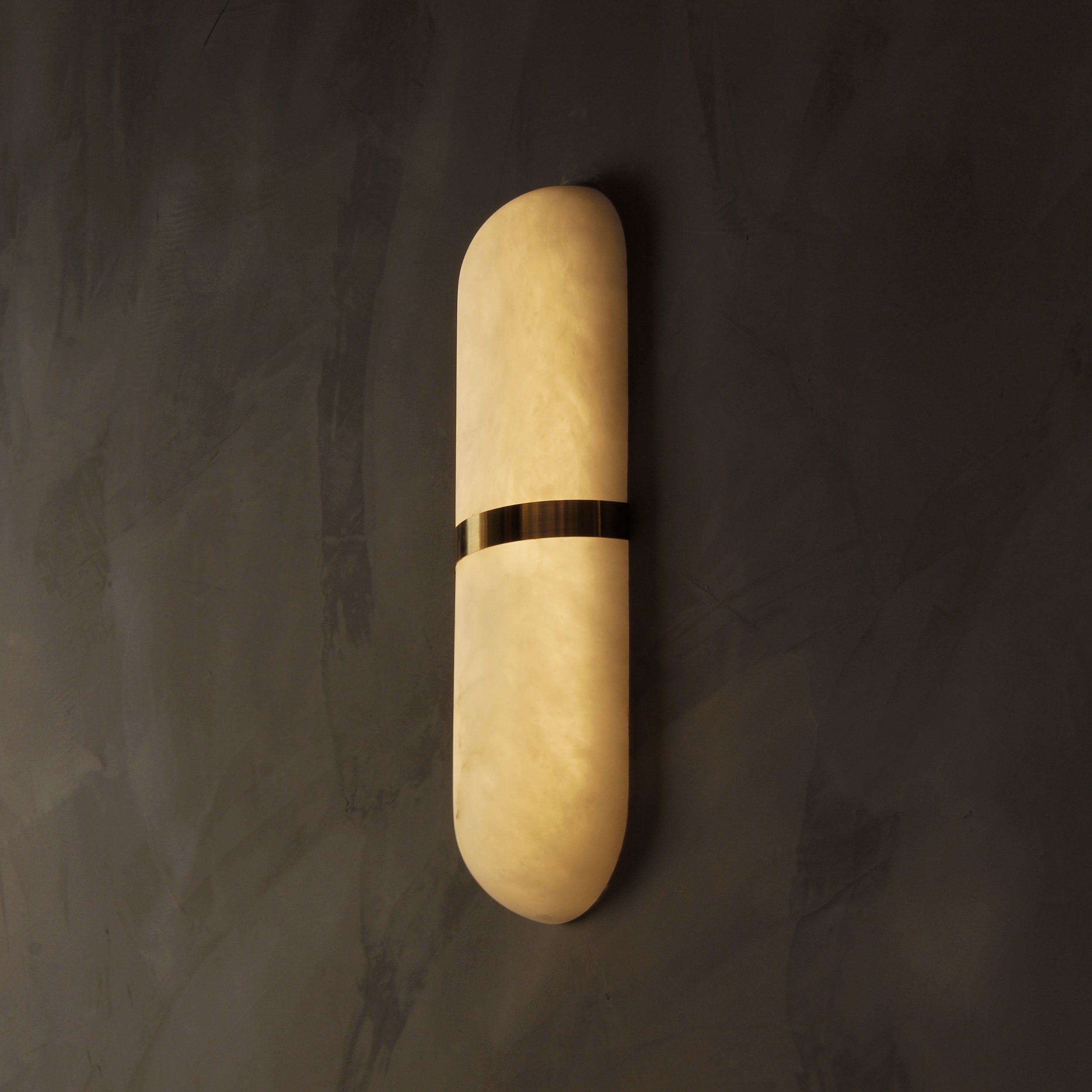 Serene luxury rounded marble wall light enhancing contemporary interior with warm diffused illumination