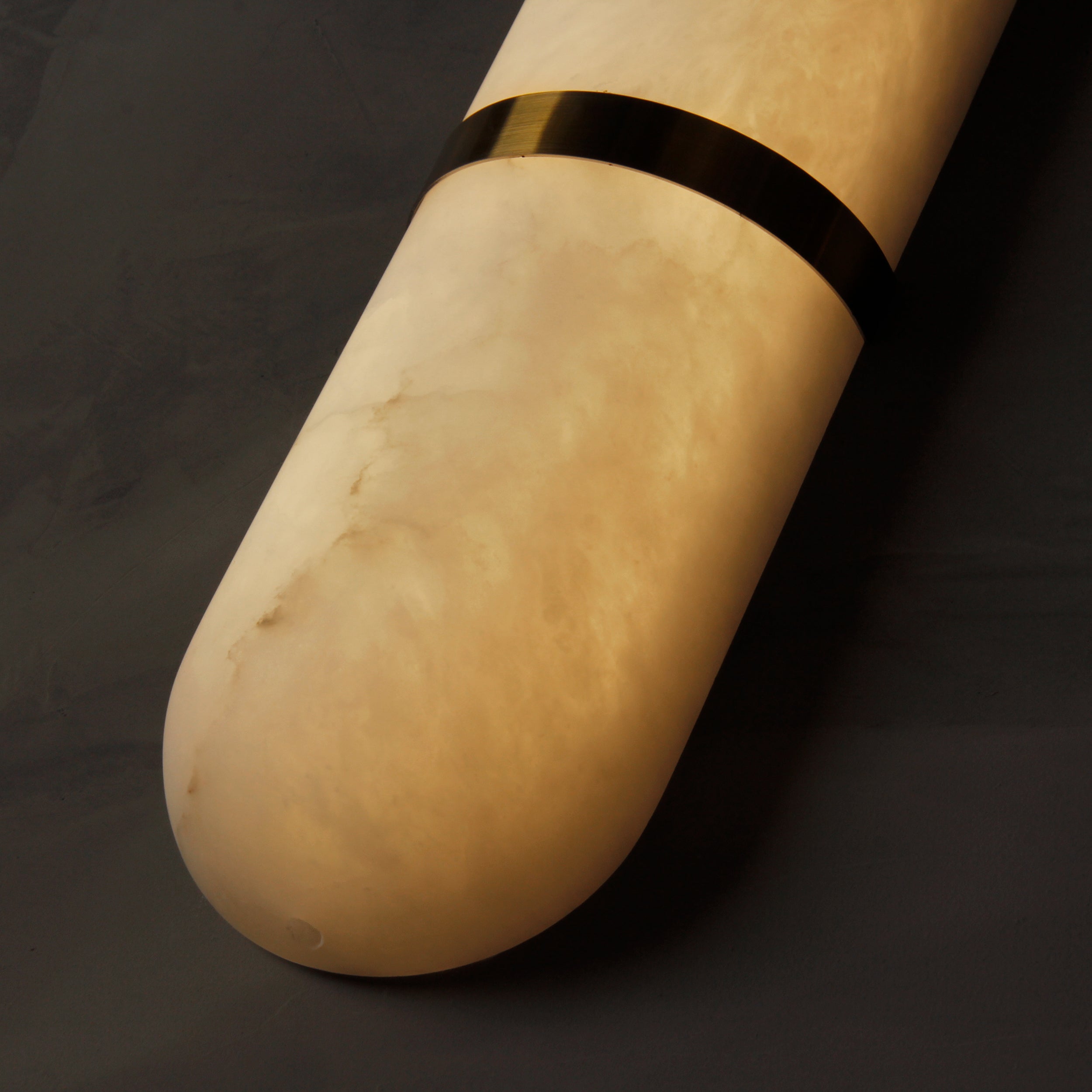 Close up of smooth rounded marble surface on Serene wall light highlighting natural stone texture