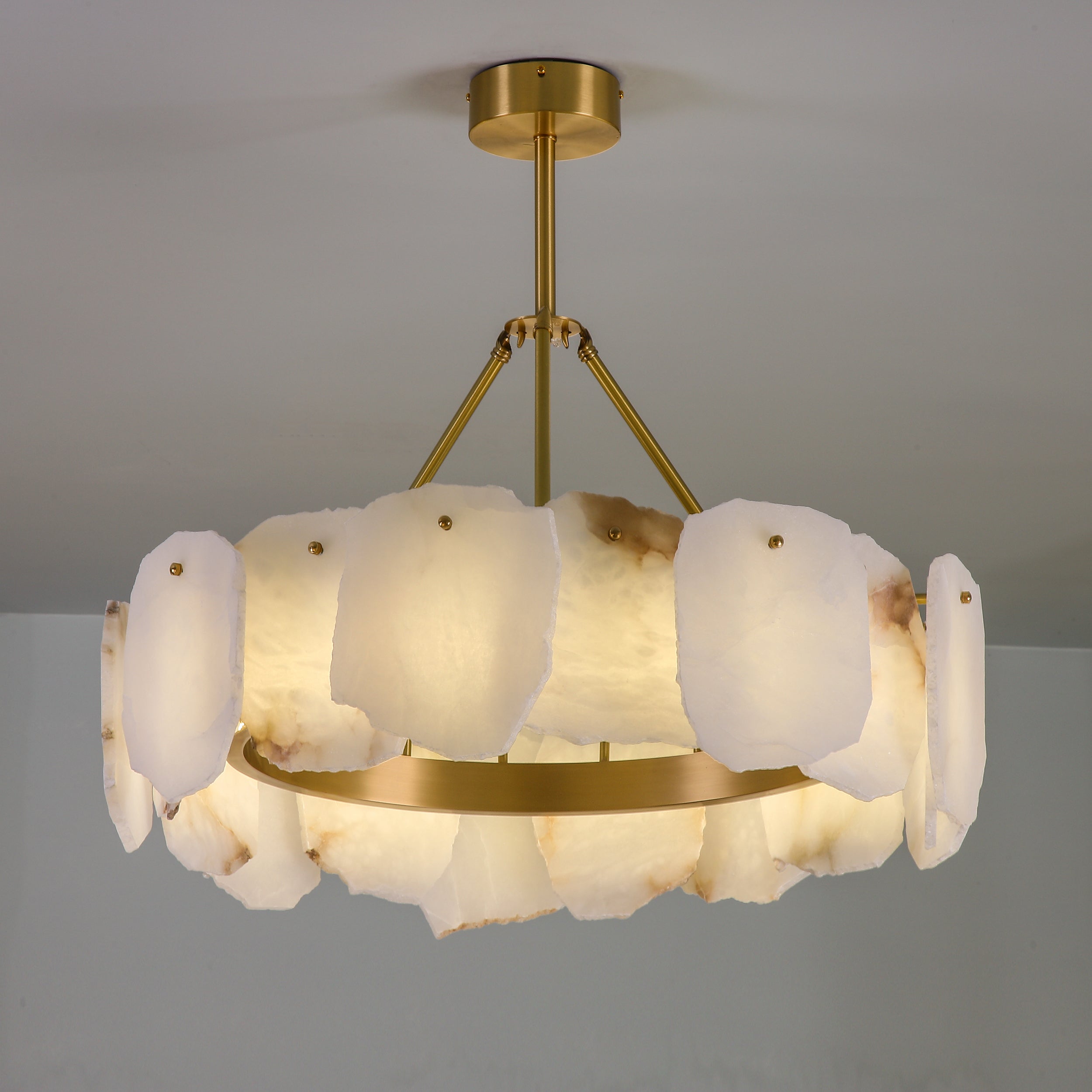 Silvio Marble Circular Chandelier II installed in refined interior showcasing layered hand carved marble panels