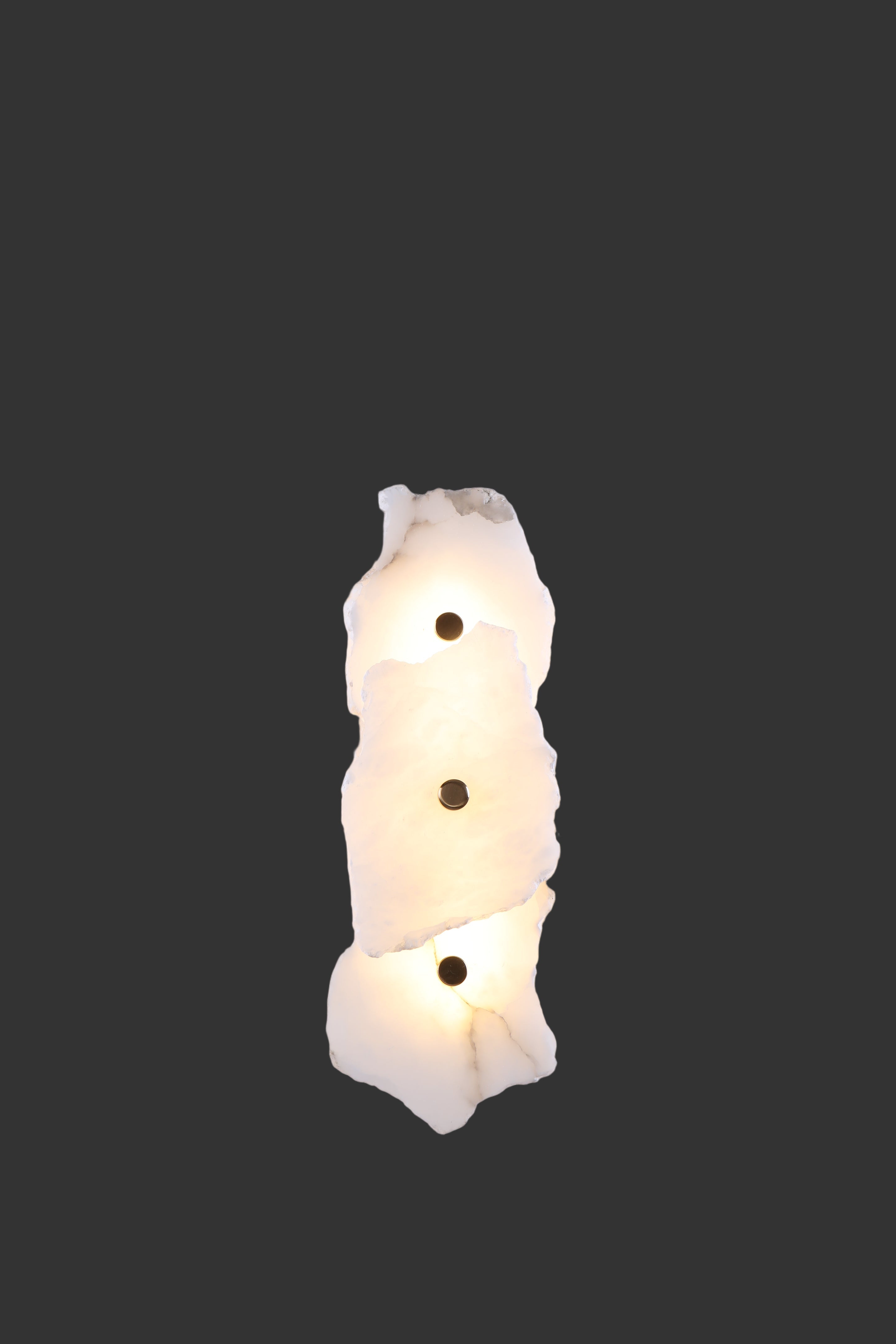 Silvio marble wall light featuring layered handcrafted stone panels arranged in organic sculptural formation
