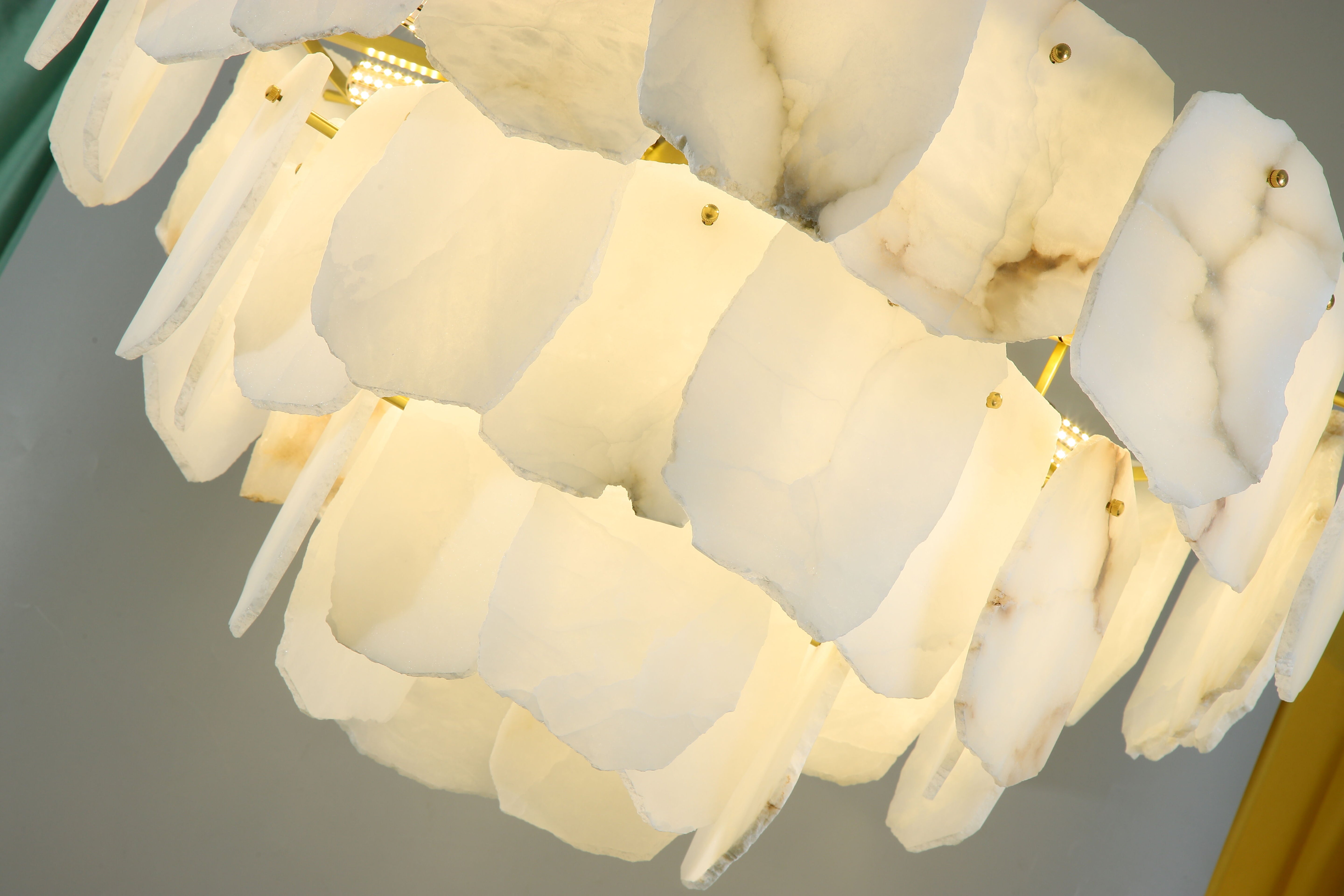 Detailed view of translucent natural marble panels on Silvio circular chandelier