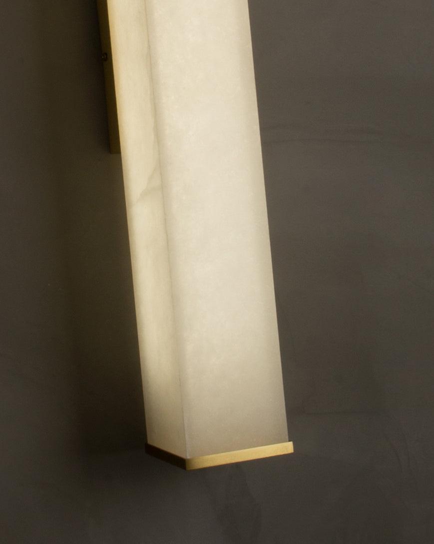 Close up of natural marble surface and slim profile on Socrates wall light