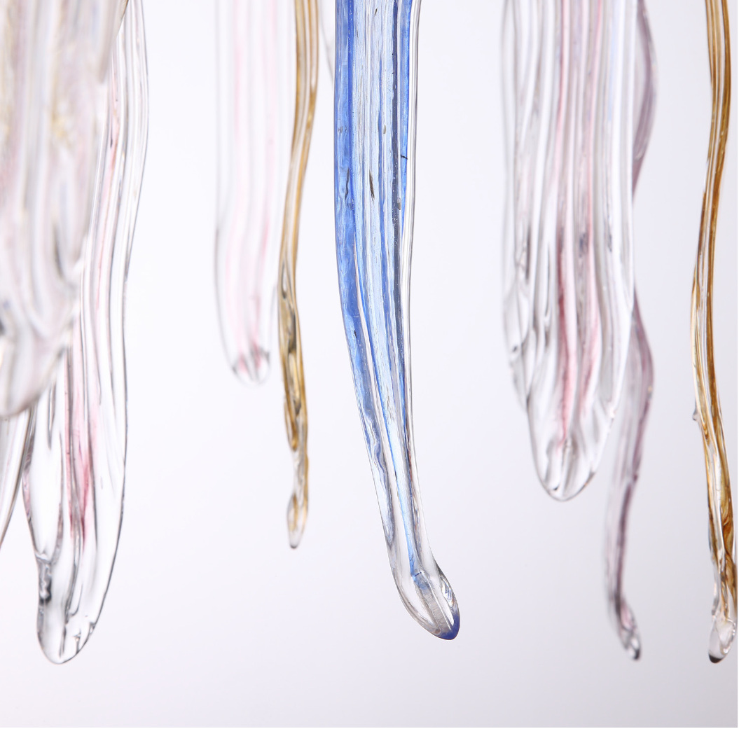 Soft ambient lighting glowing through the hand-formed glass icicles of the chandelier, emphasizing its luxury aesthetic.