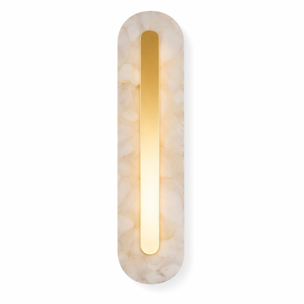 The elongated, sleek form of the Treviso Marble Wall Light creates a sophisticated mood with its soft, warm glow radiating against a textured interior wall.