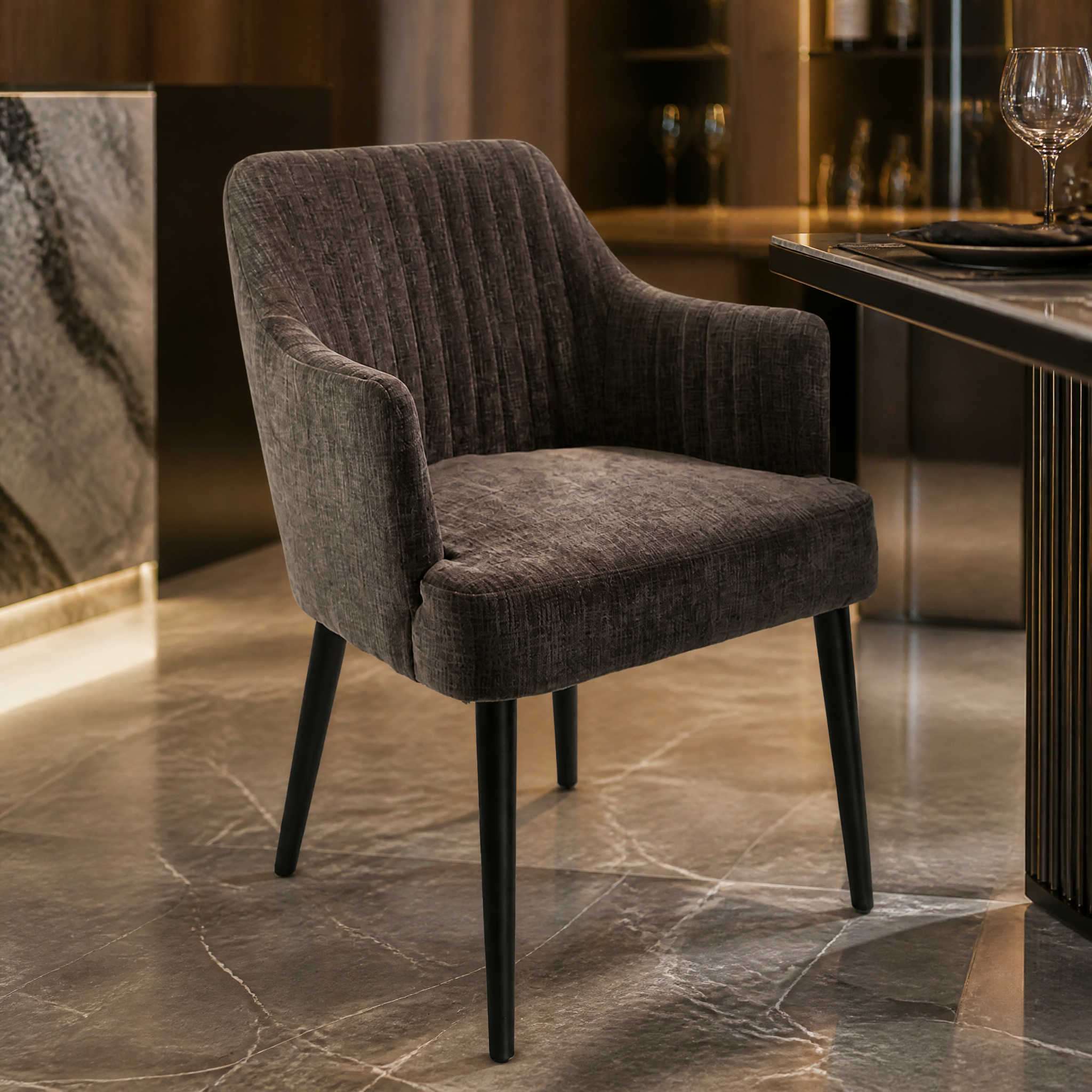The VORELLI Blevano dining chair showcases its sleek black frame and moody, sophisticated vintage character in a styled contemporary interior.