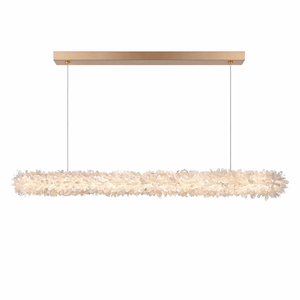 The VORELLI Quartz Linear Rectangular Chandelier casts a dramatic, moody glow across a sleek kitchen island, highlighting the unique depth of its crystal shards.